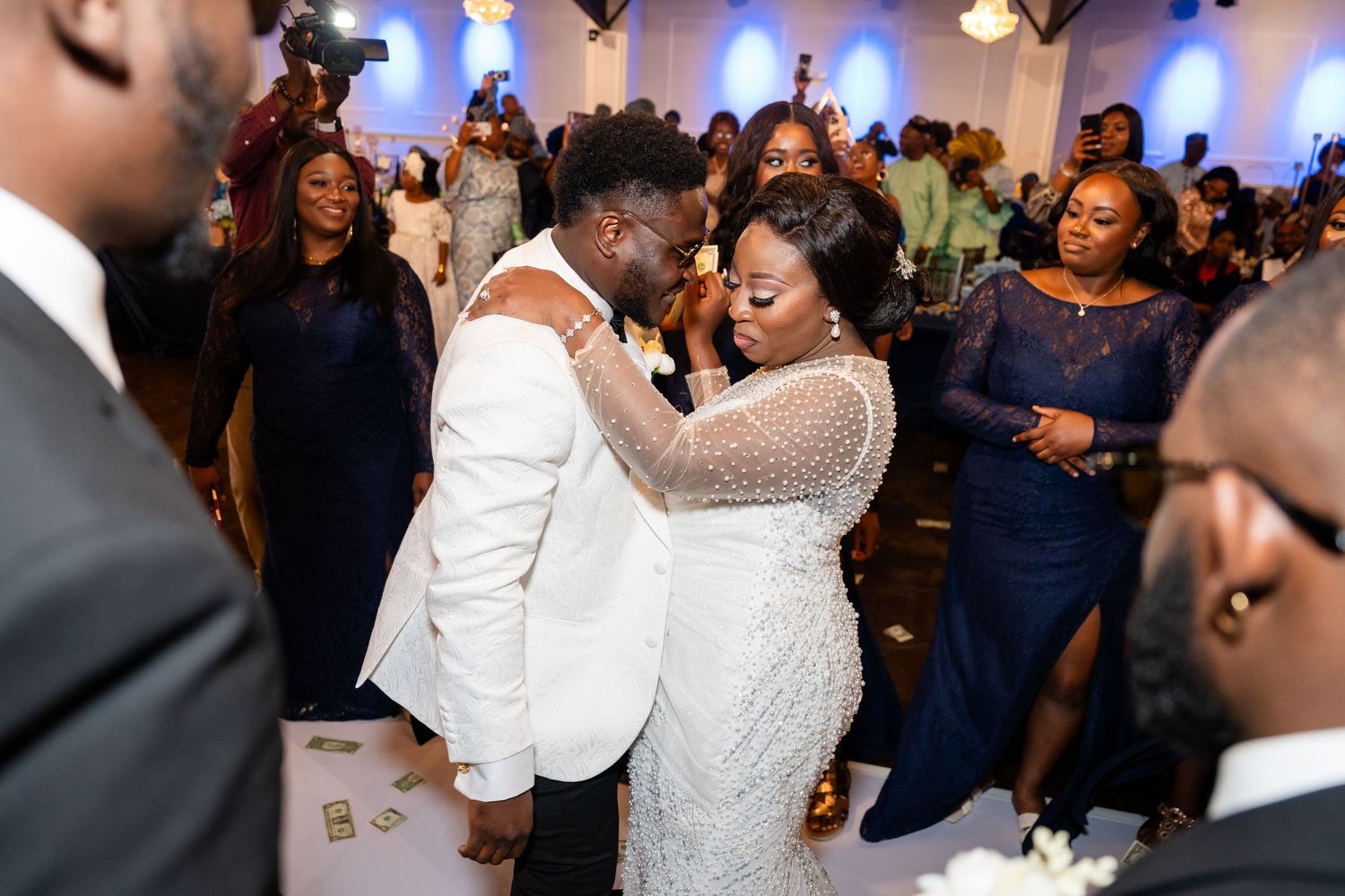 Wedding reception dance floor filled with celebrating guests in formal attire.