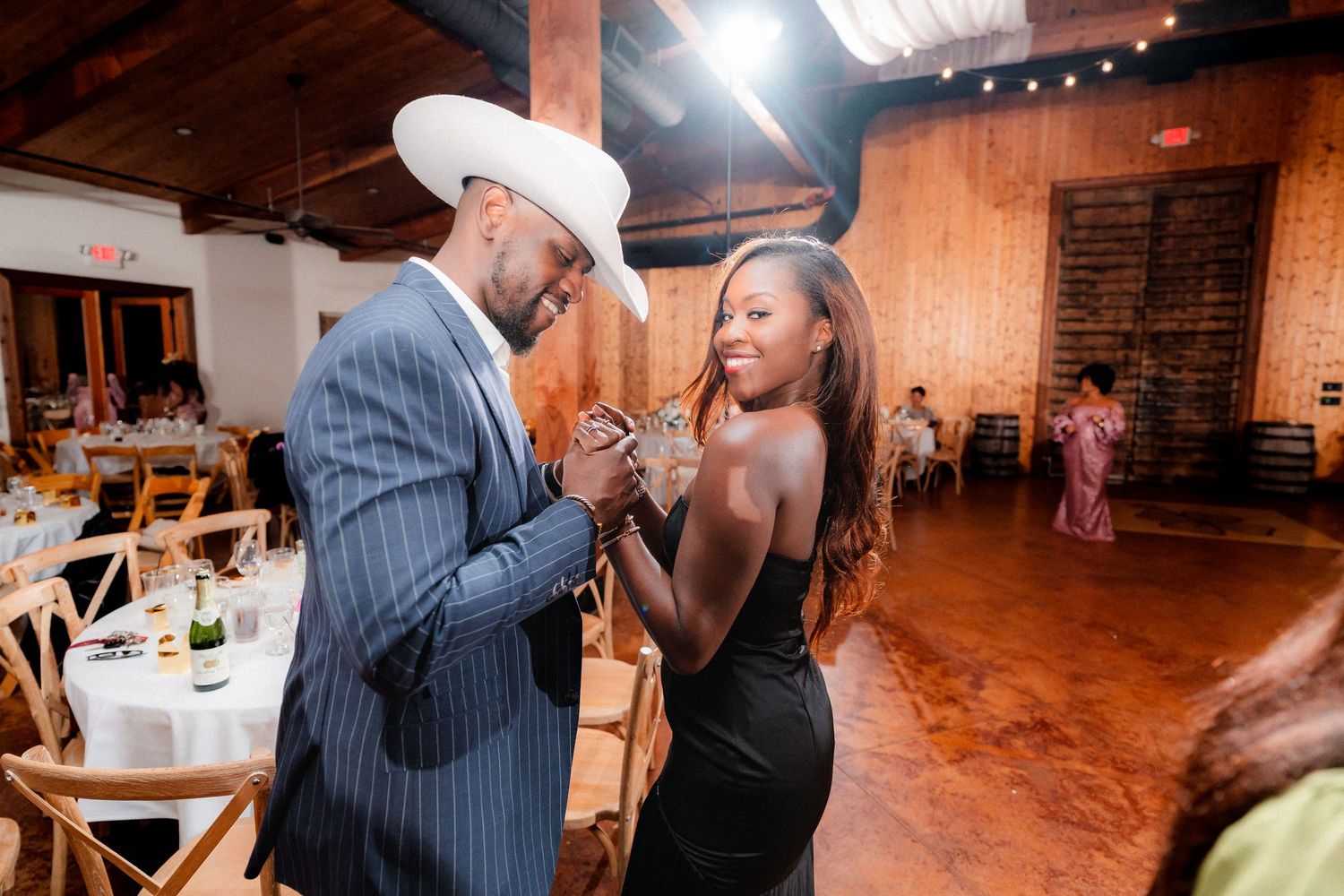 Wedding celebration candid moments captured on the dance floor with guests enjoying the party.