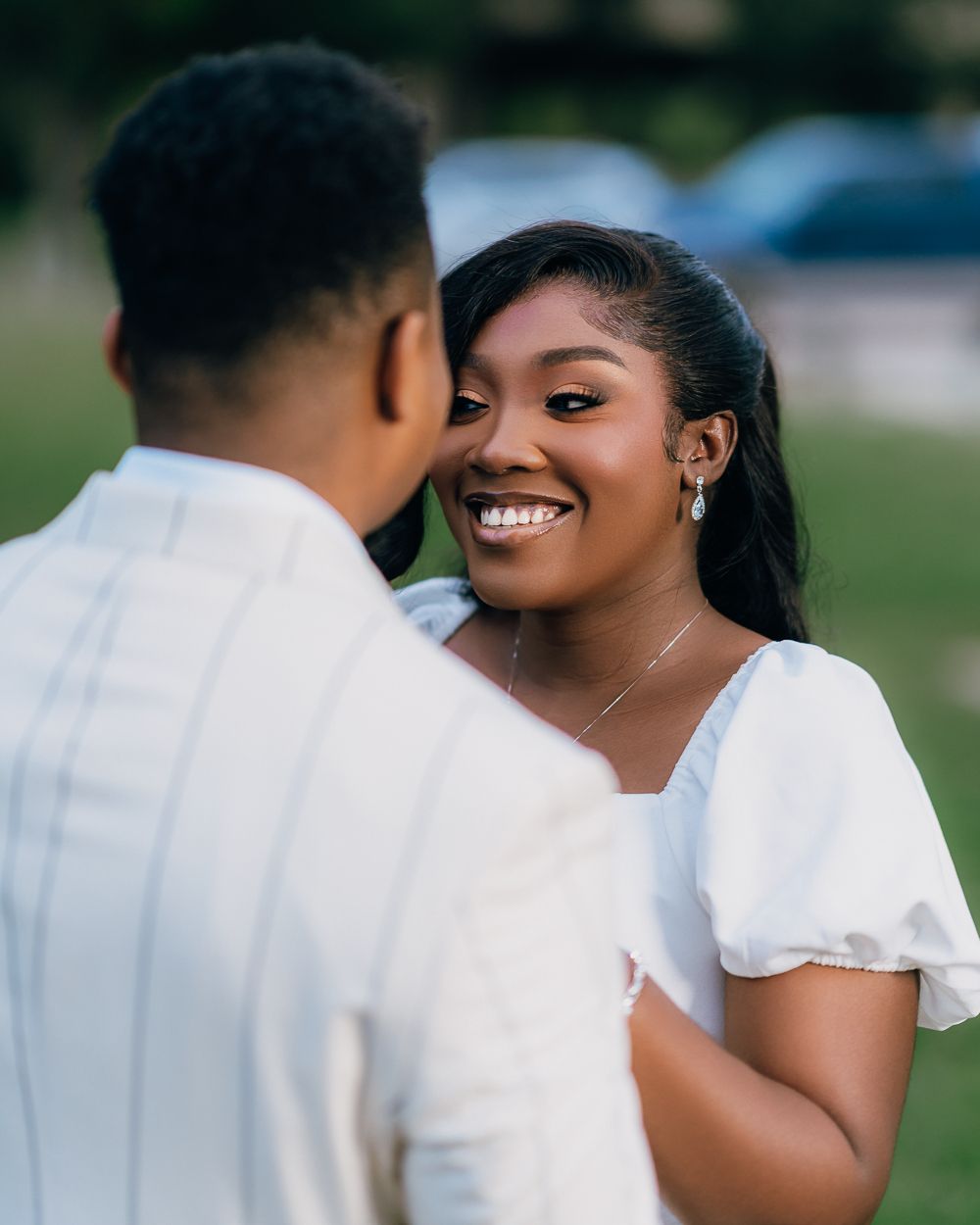 An intimate series of photos showing a couple in white attire sharing joyful moments during an outdoor shoot.