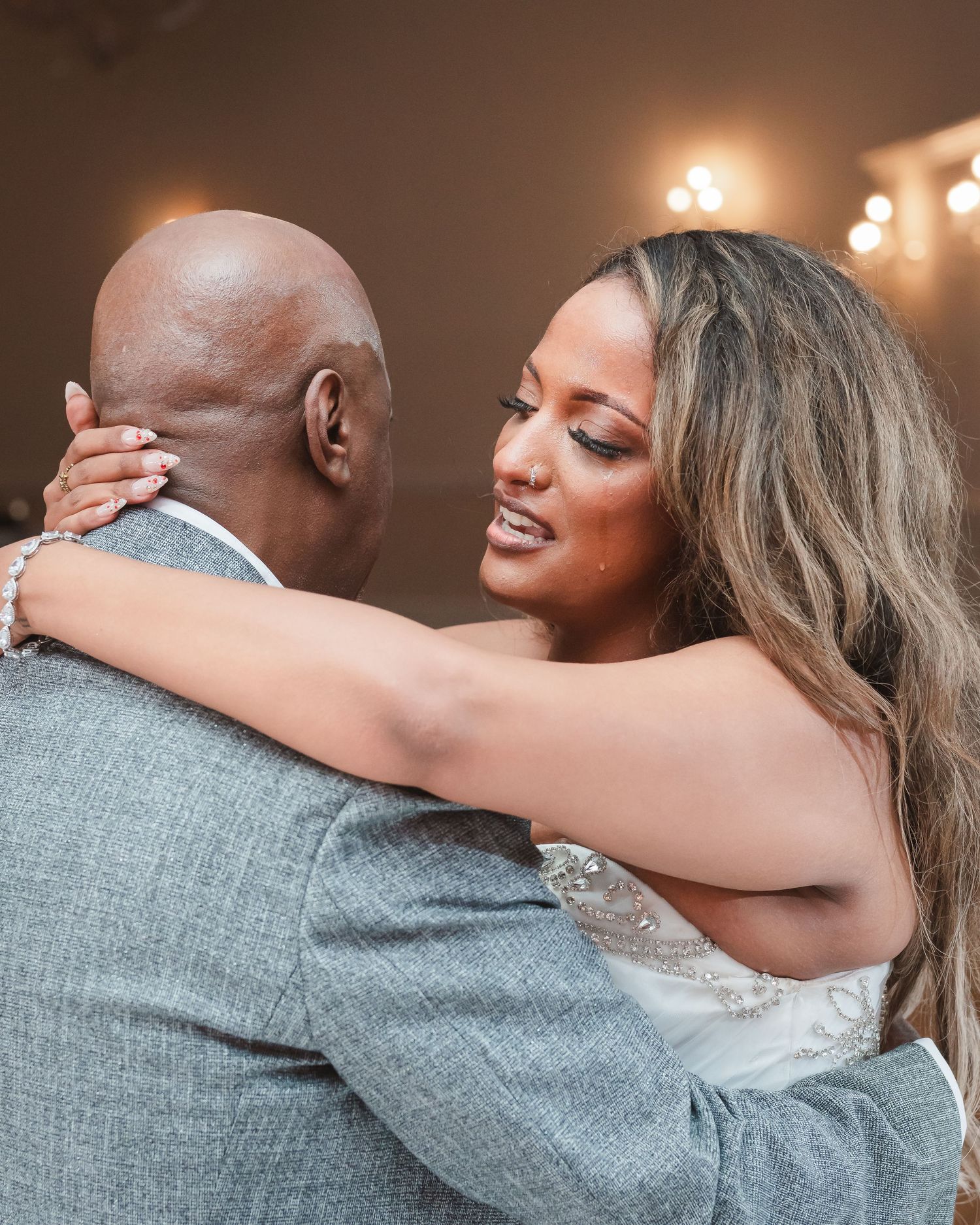 Romantic first dance moment between newlyweds at wedding reception.