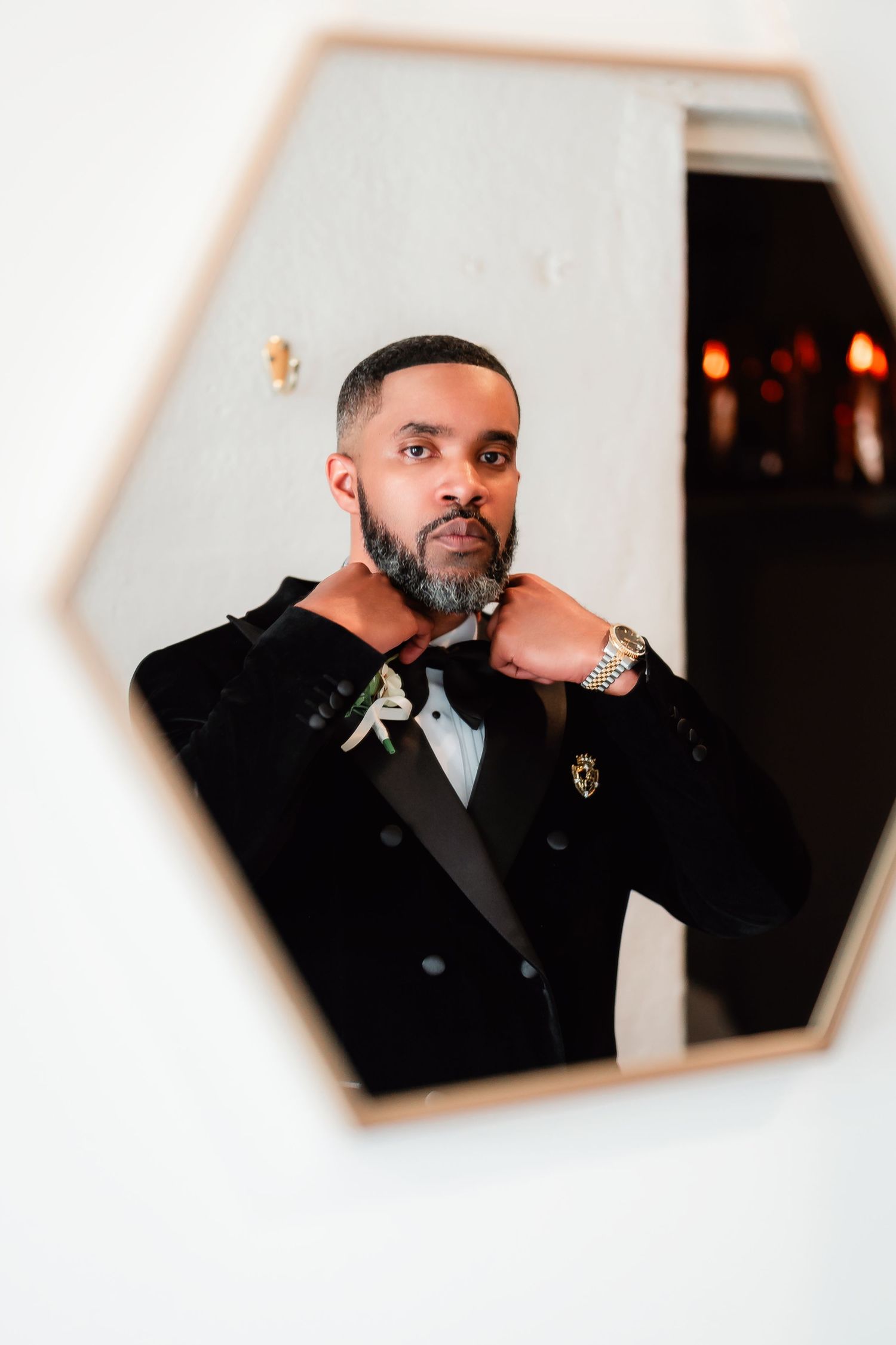 Artistic wedding photo captured through hexagonal mirrors showing reflections in formal attire.