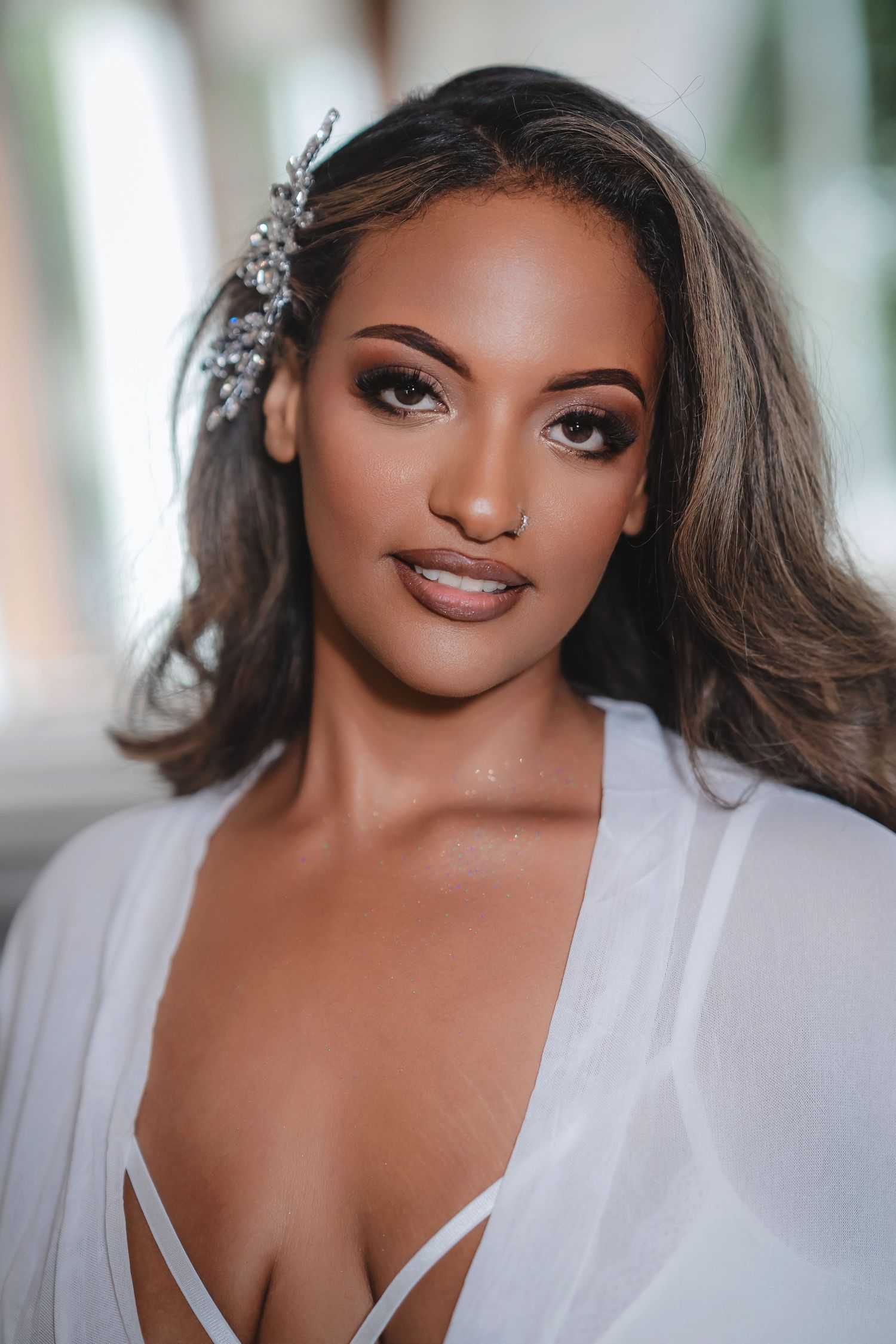 Close-up bridal portrait with soft lighting and elegant makeup.