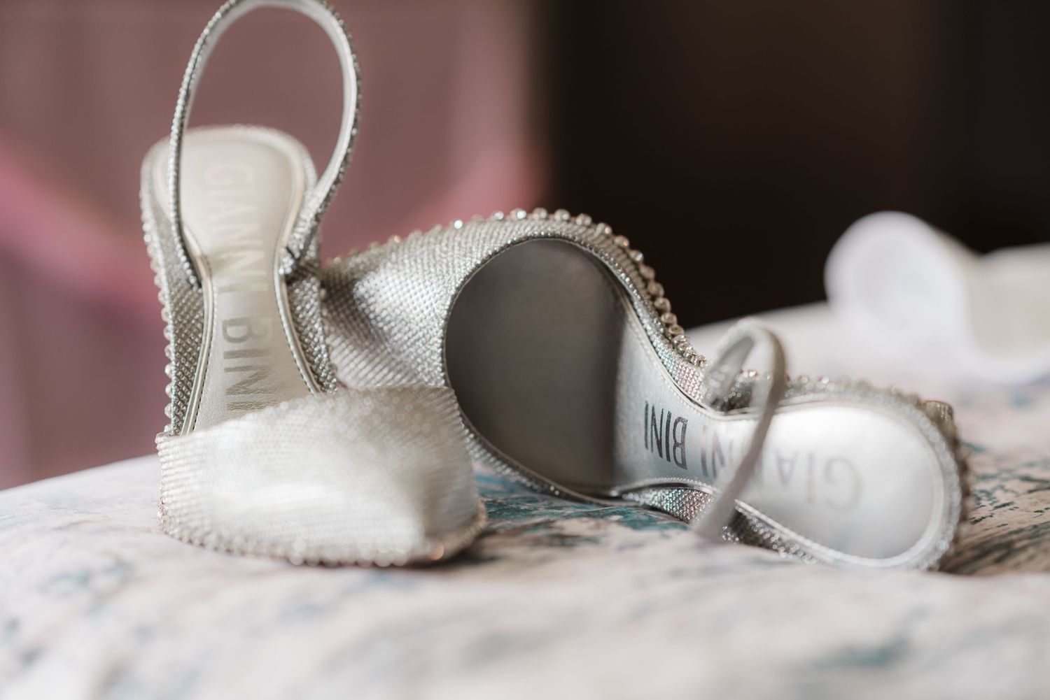 Close-up detail shot of silver bridal shoes with delicate embellishments.