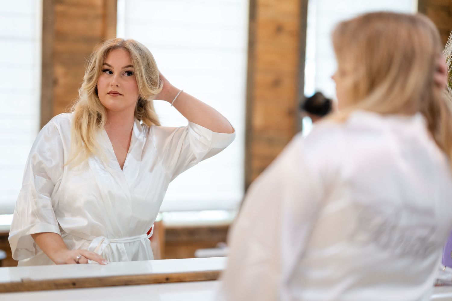 Getting ready scene in a rustic bridal suite with exposed brick walls.