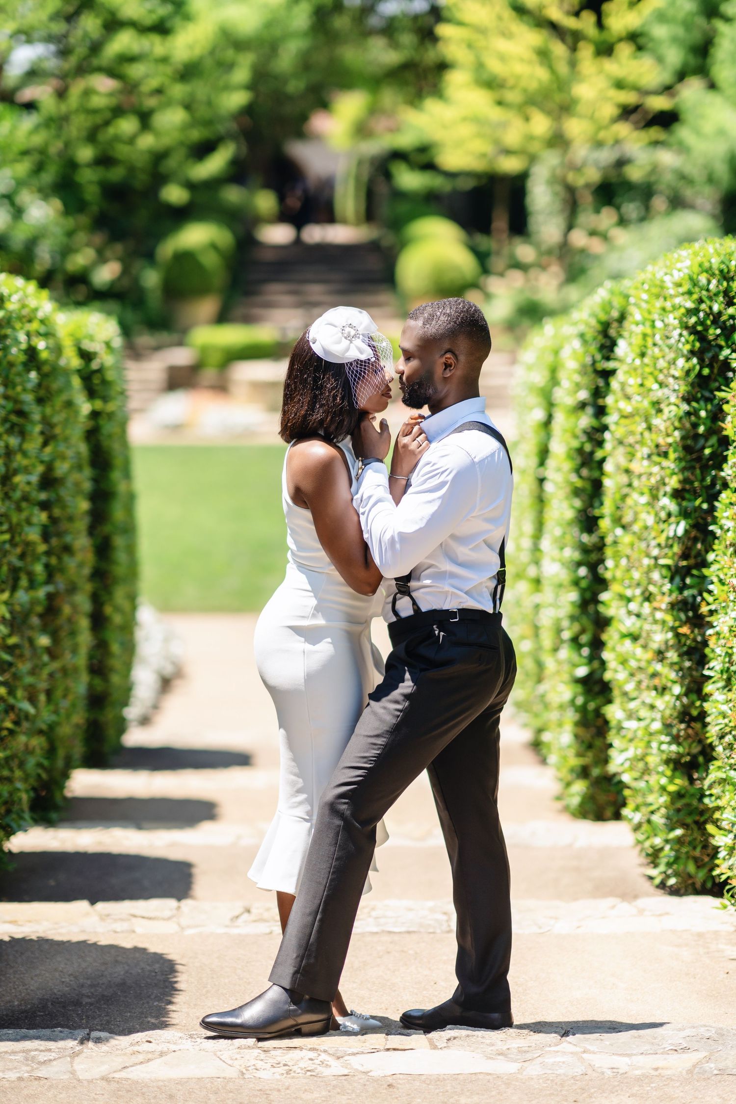 A romantic sequence of wedding photos showing a couple dancing together on a garden path surrounded by greenery.