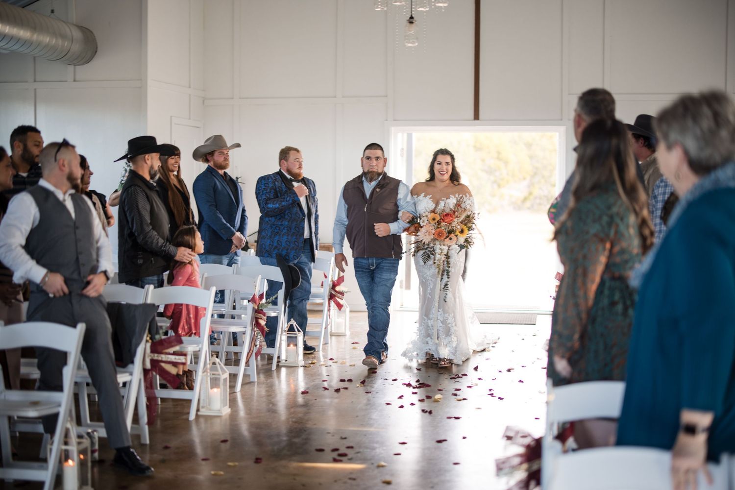 Wedding reception candid moments captured inside a bright, modern venue space.