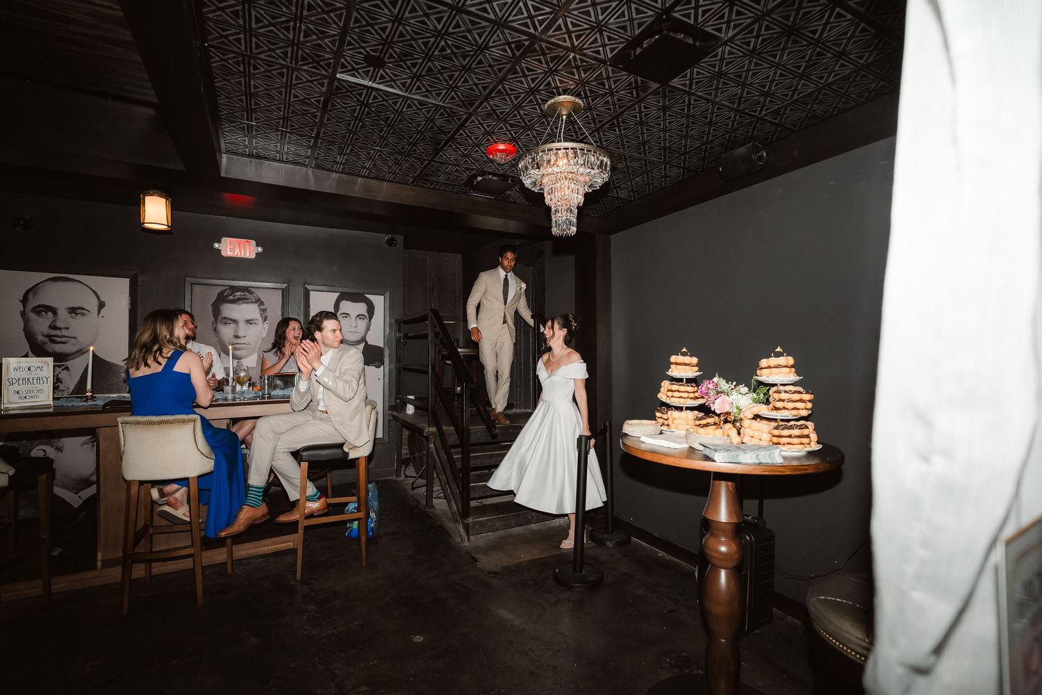 Wedding reception in a dimly lit venue with vintage ceiling details.