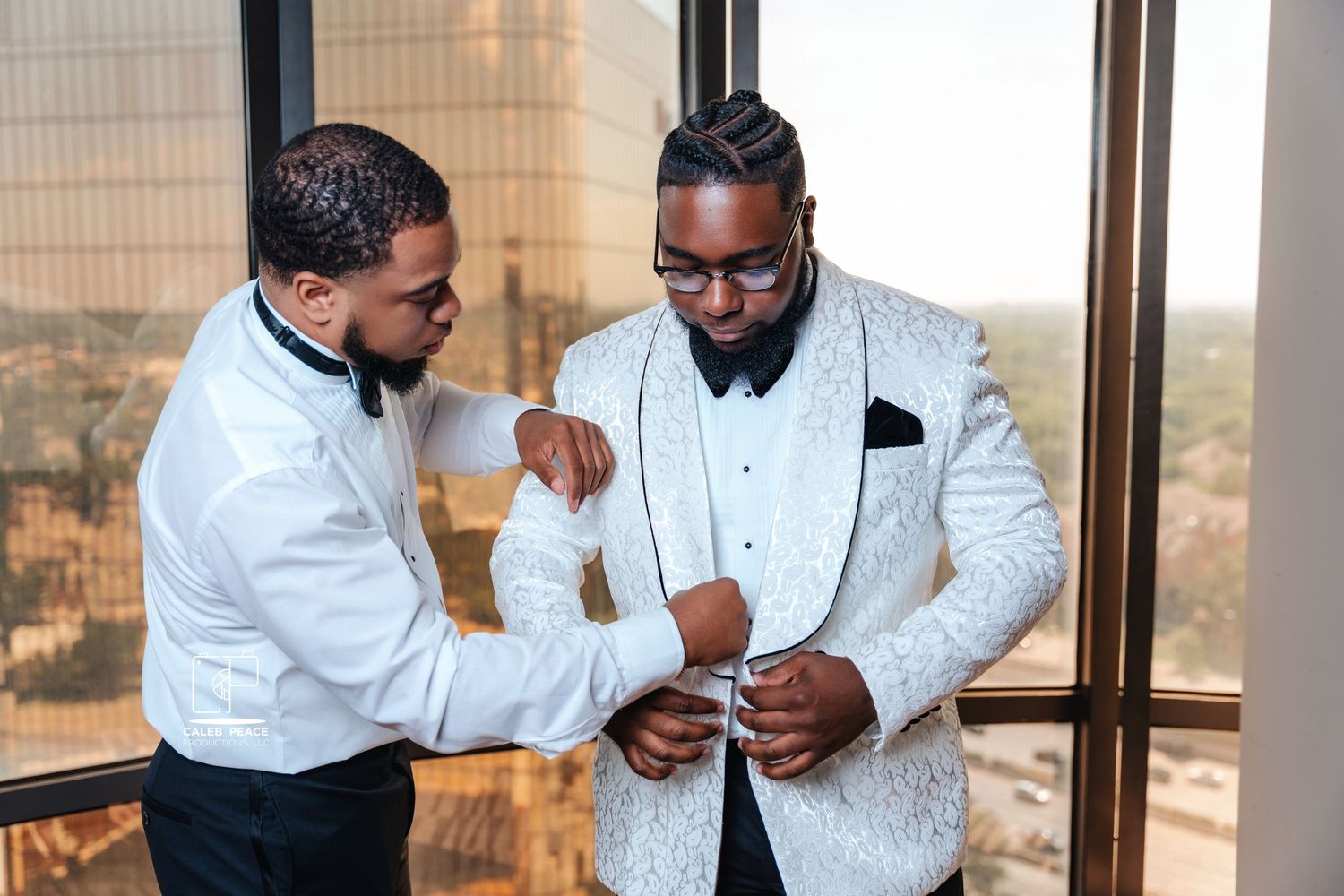 Groomsmen in white jackets preparing for the wedding ceremony.