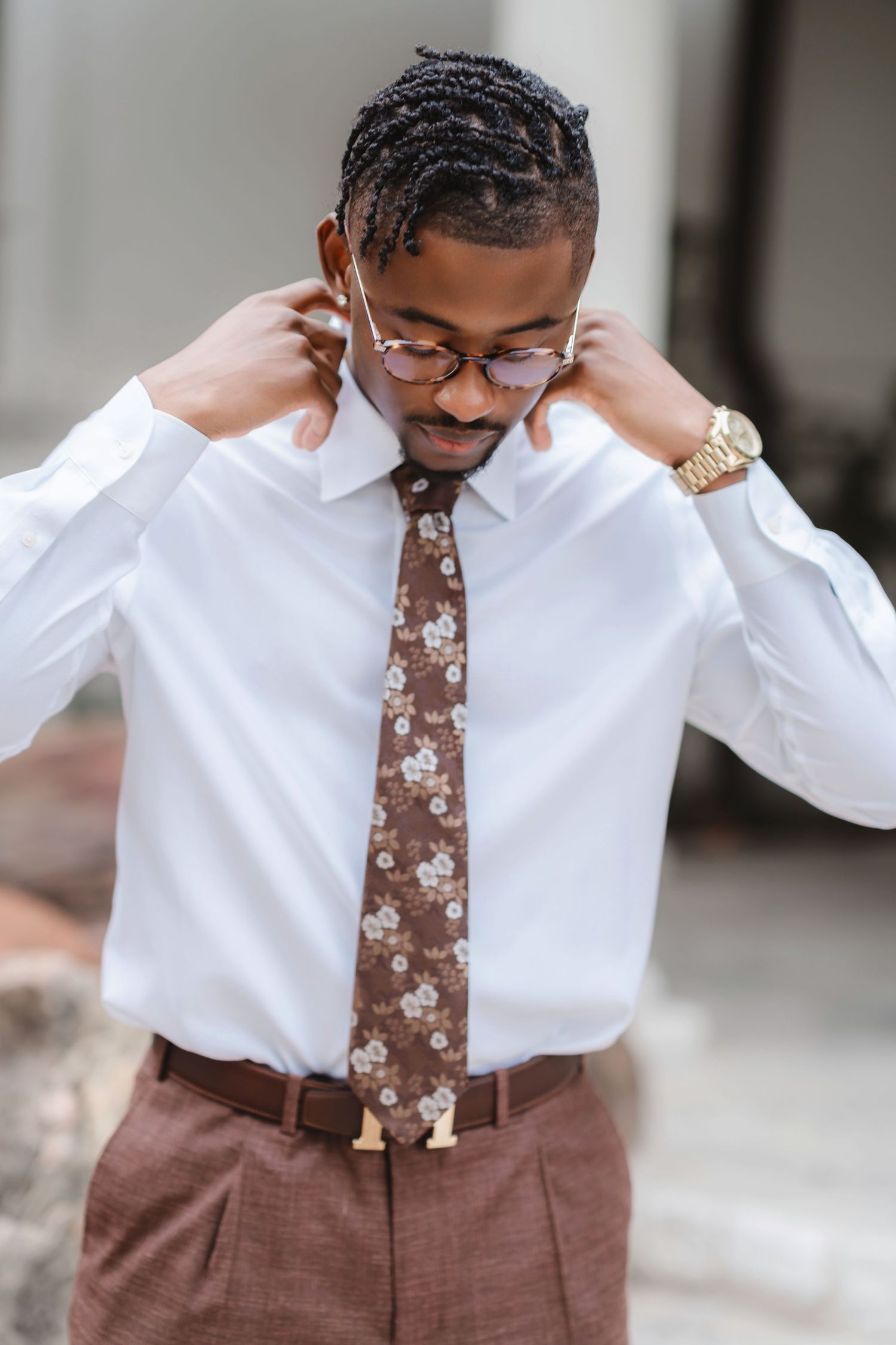 Wedding attire details showing brown floral tie and white dress shirt.