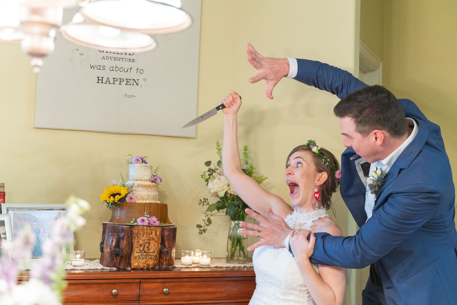A bride and groom celebrate joyfully during their wedding reception in a yellow-walled venue.