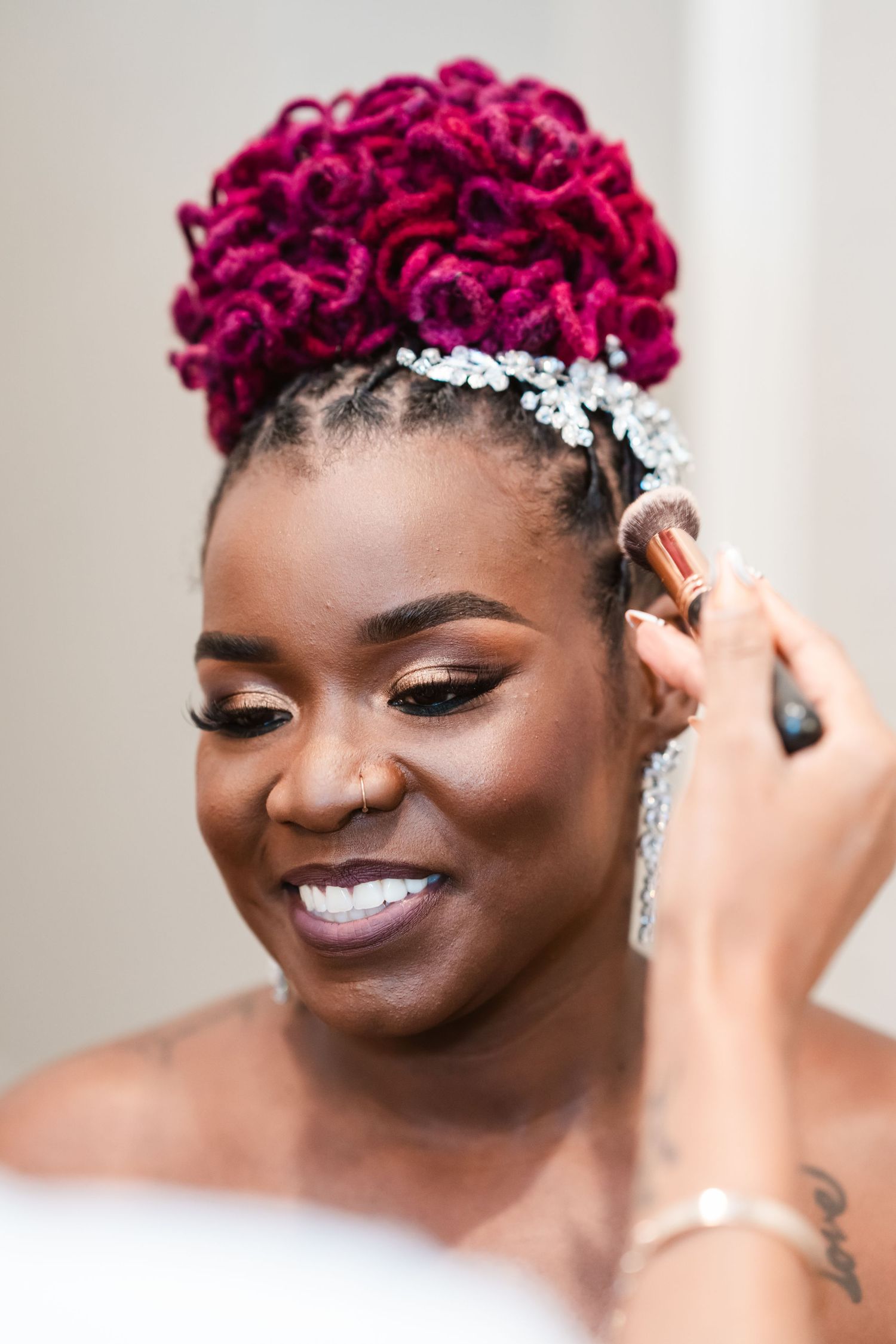 Stunning bridal beauty look featuring magenta hair and crystal accessories.