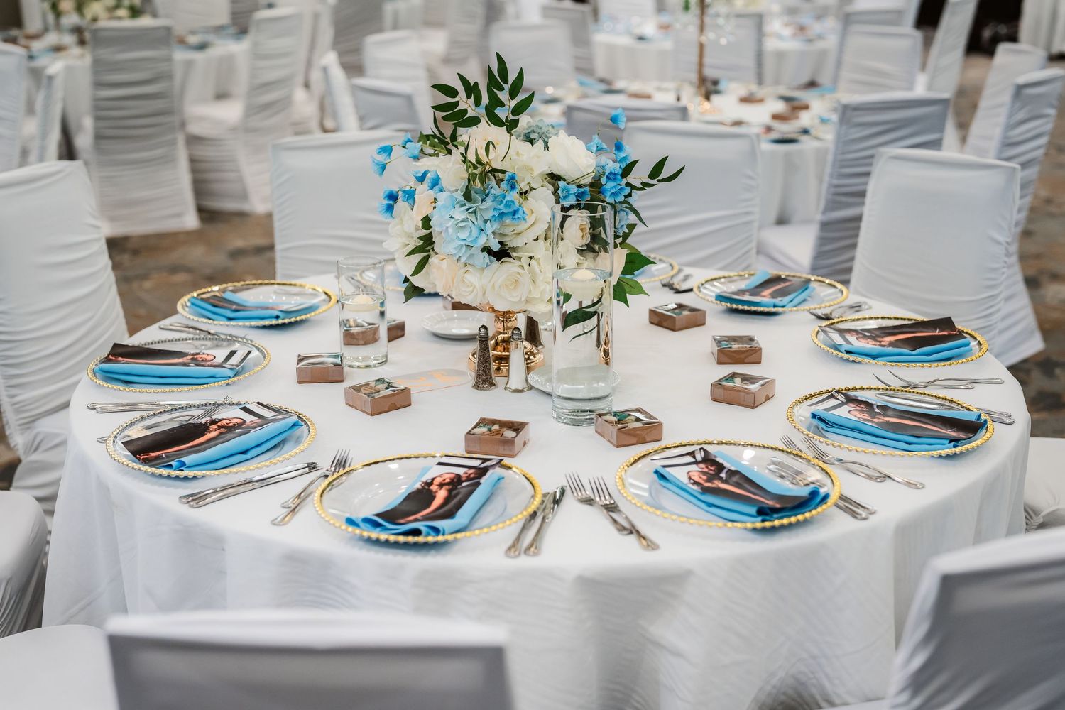 Elegant wedding reception tables set with white linens and turquoise accents.
