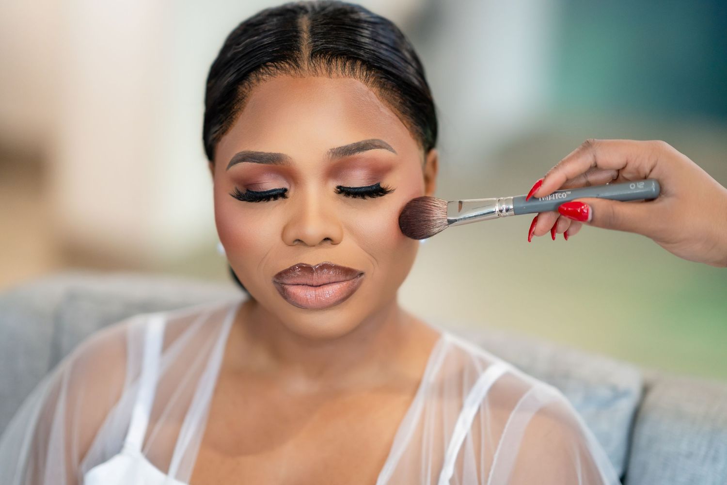 Close-up shots of bridal makeup application with soft glam finish.