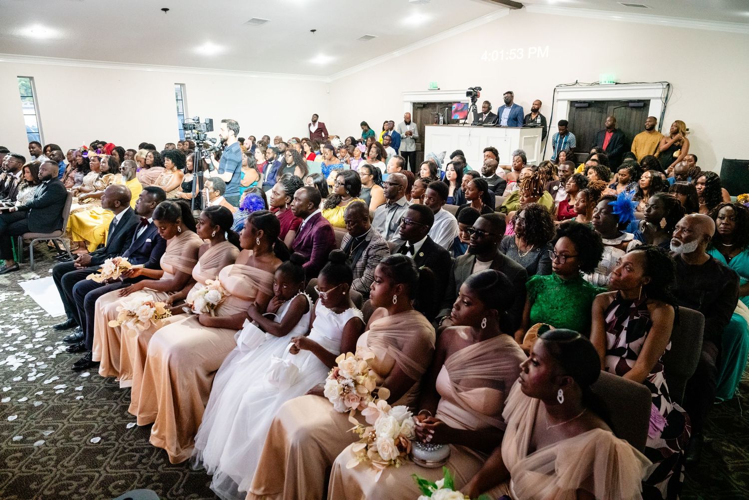 Large wedding ceremony audience seated in rows watching the celebration.