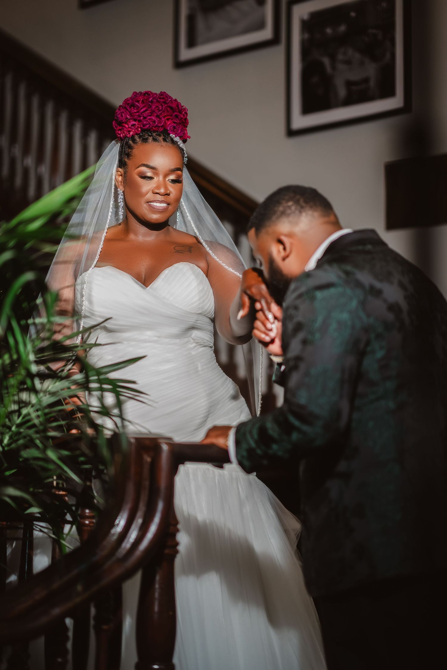 An intimate moment between newlyweds during their first look in a warmly lit indoor setting.
