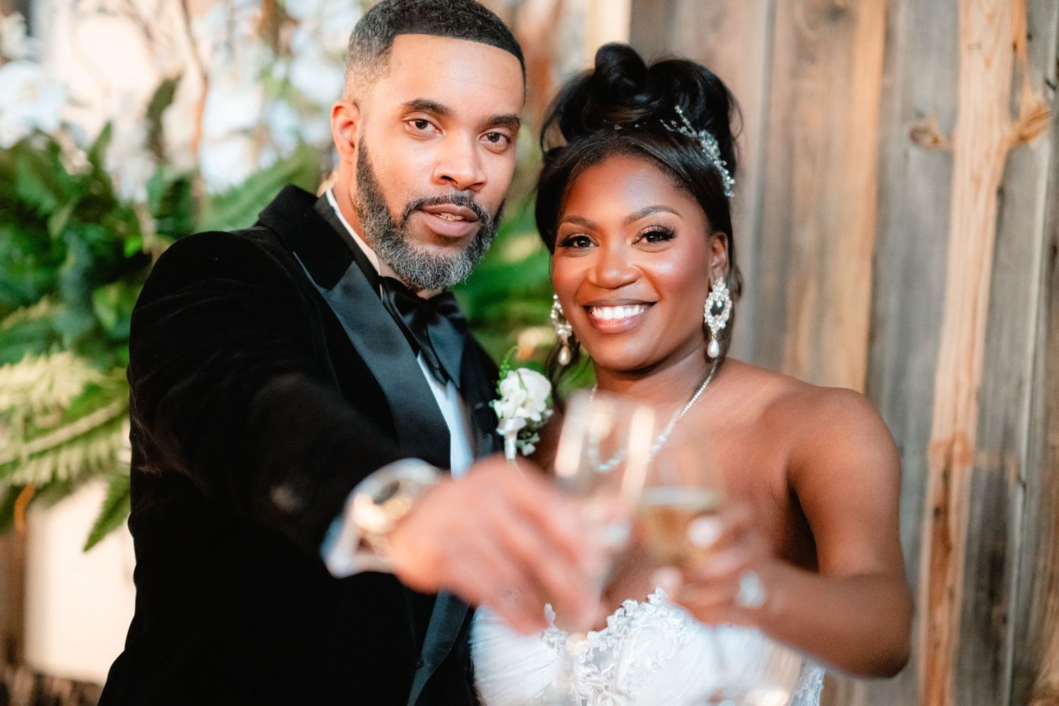 A joyful couple shares an intimate moment during their wedding celebration outdoors.