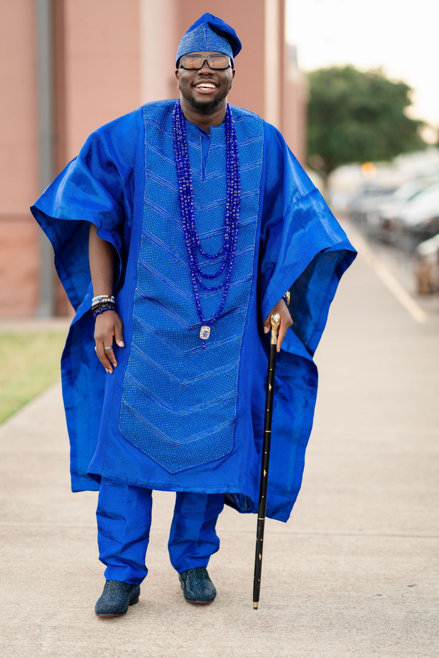 Traditional blue African agbada outfit with intricate embroidery details.