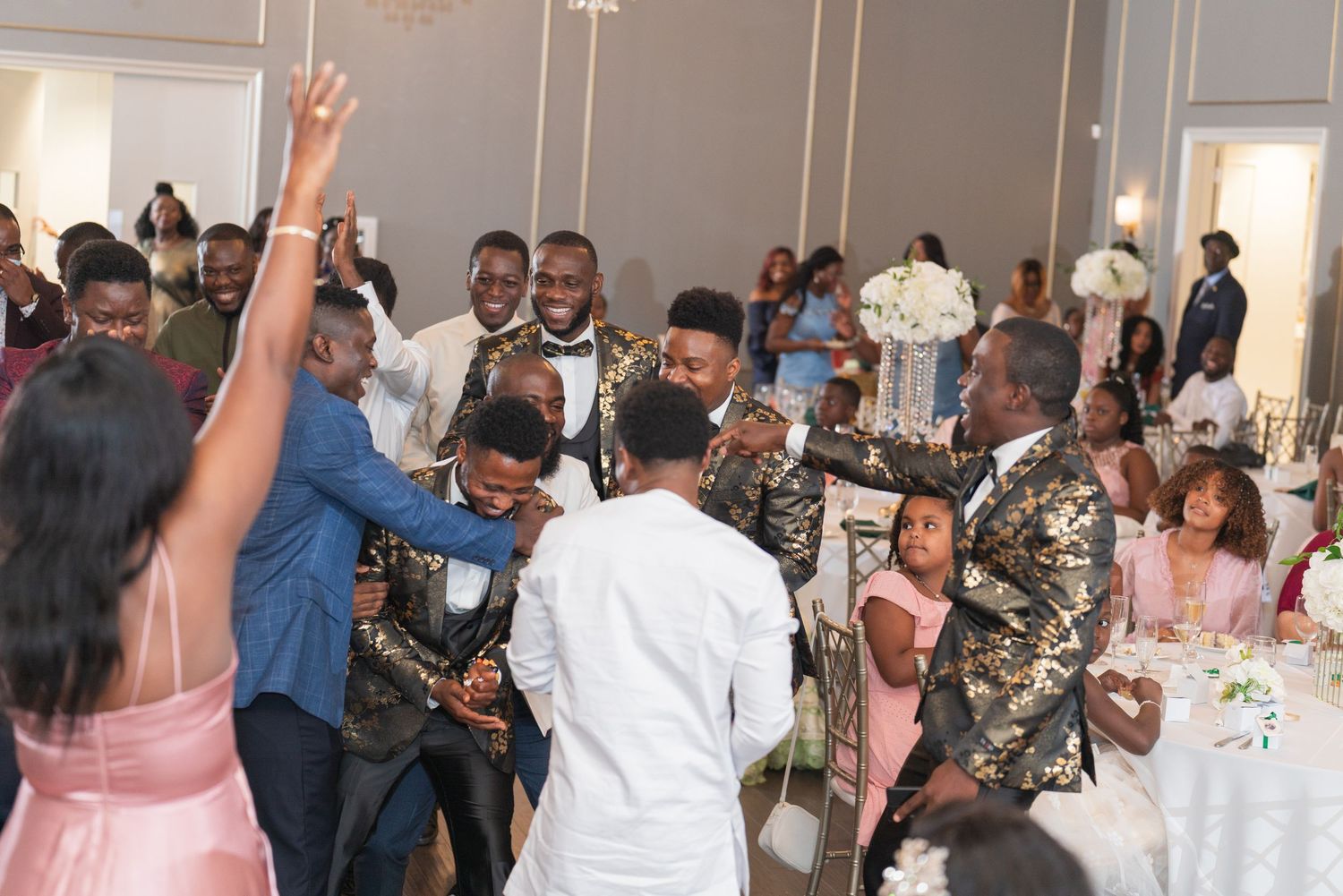 Wedding reception celebration with guests dancing and enjoying the festivities in an elegant venue.