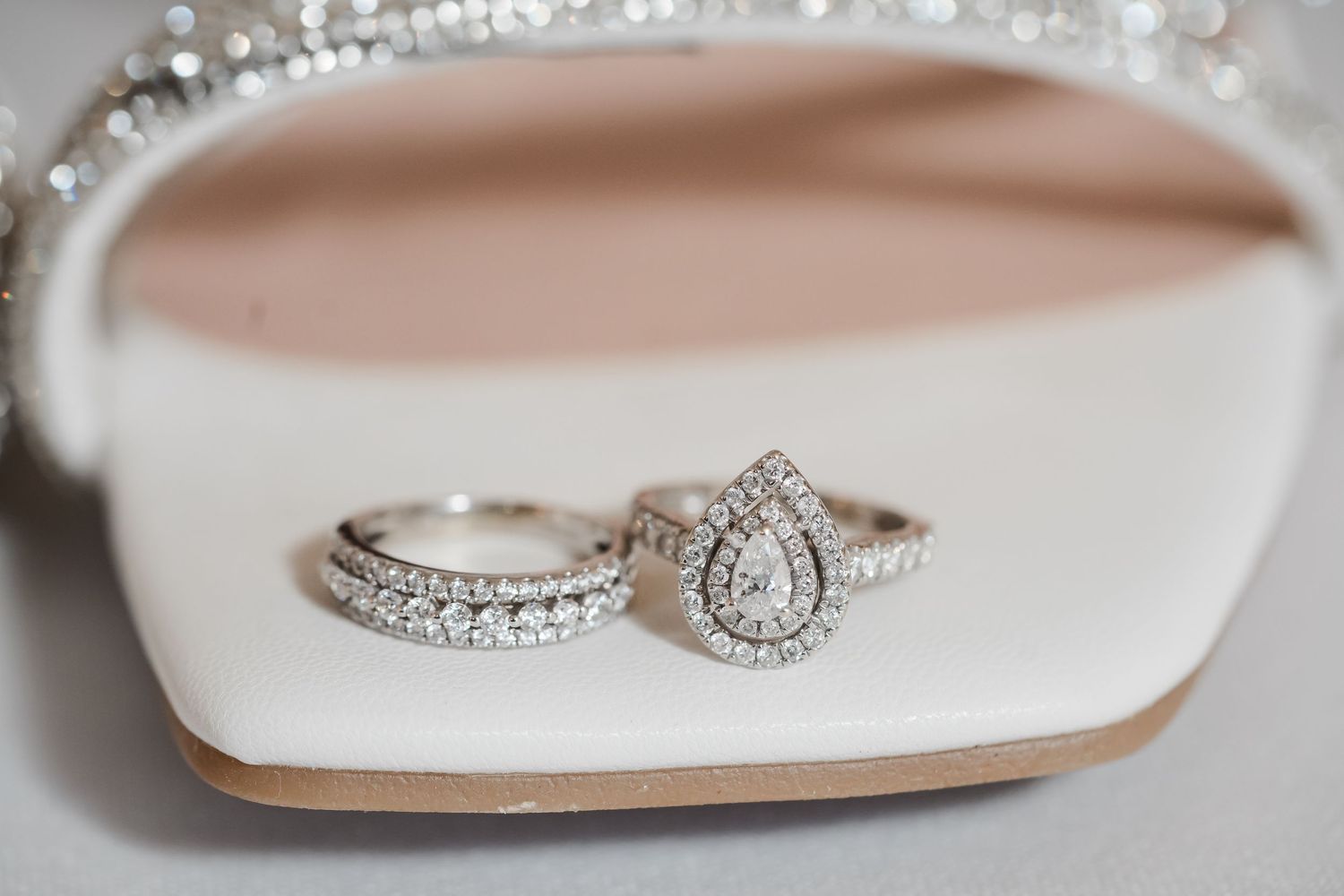Sparkling diamond engagement ring with halo design photographed from multiple angles on a white surface.