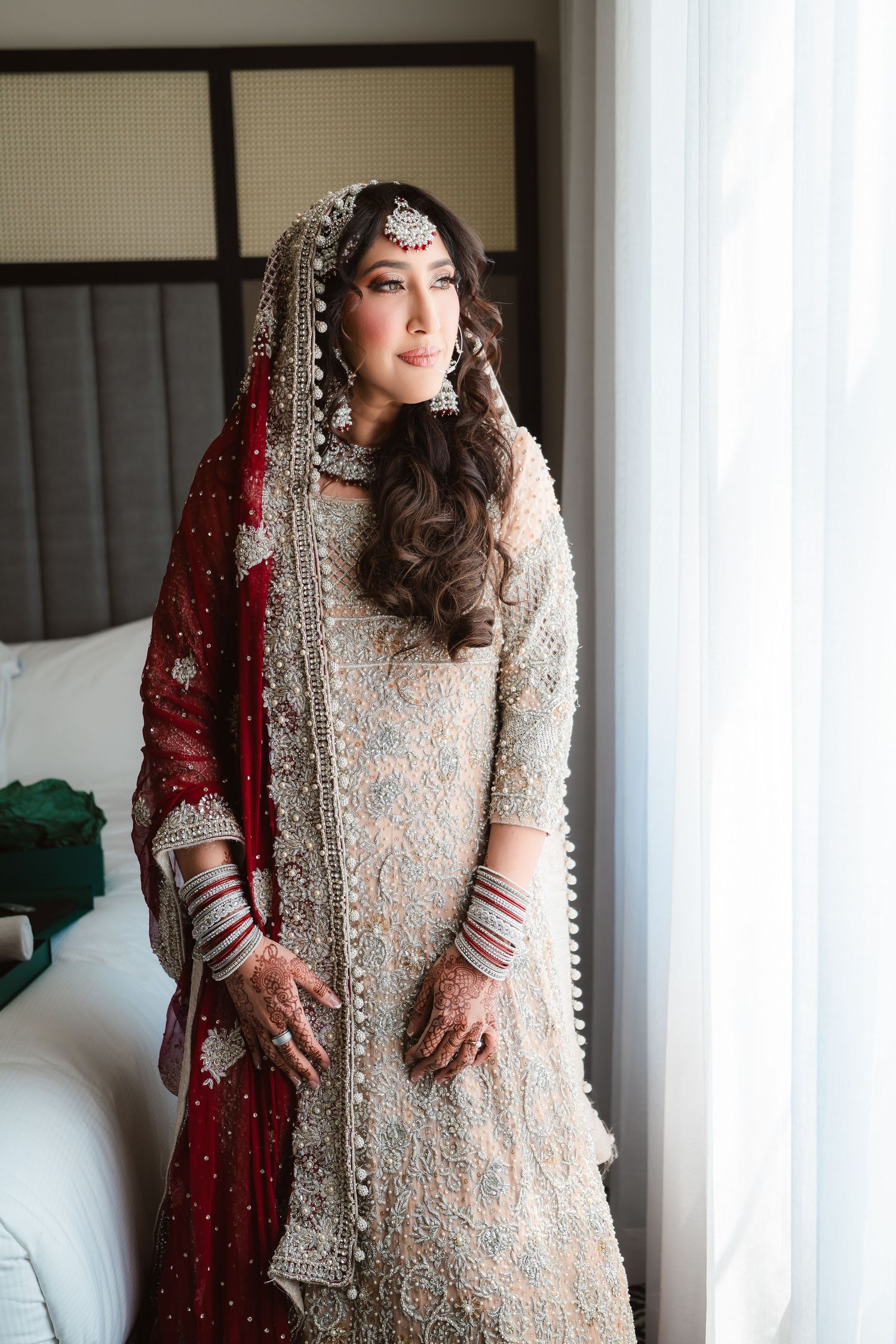 Elegant bridal portraits showing intricate silver beadwork and red dupatta details.