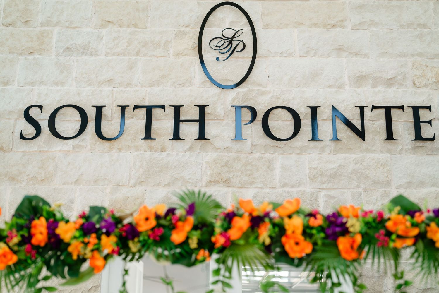 South Pointe venue sign displayed with colorful floral decorations.