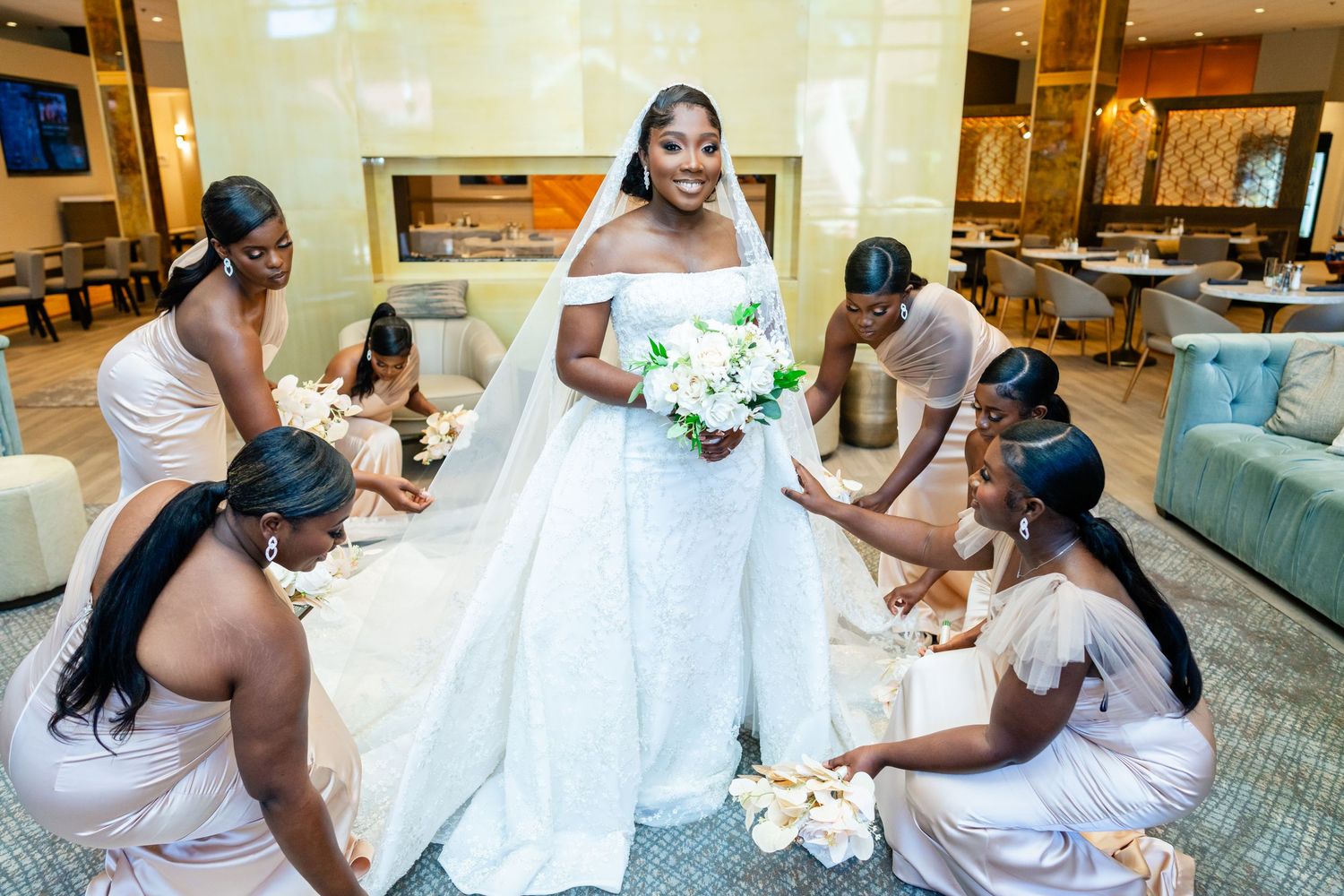 Wedding celebration with bridal party dancing and celebrating in a reception hall.