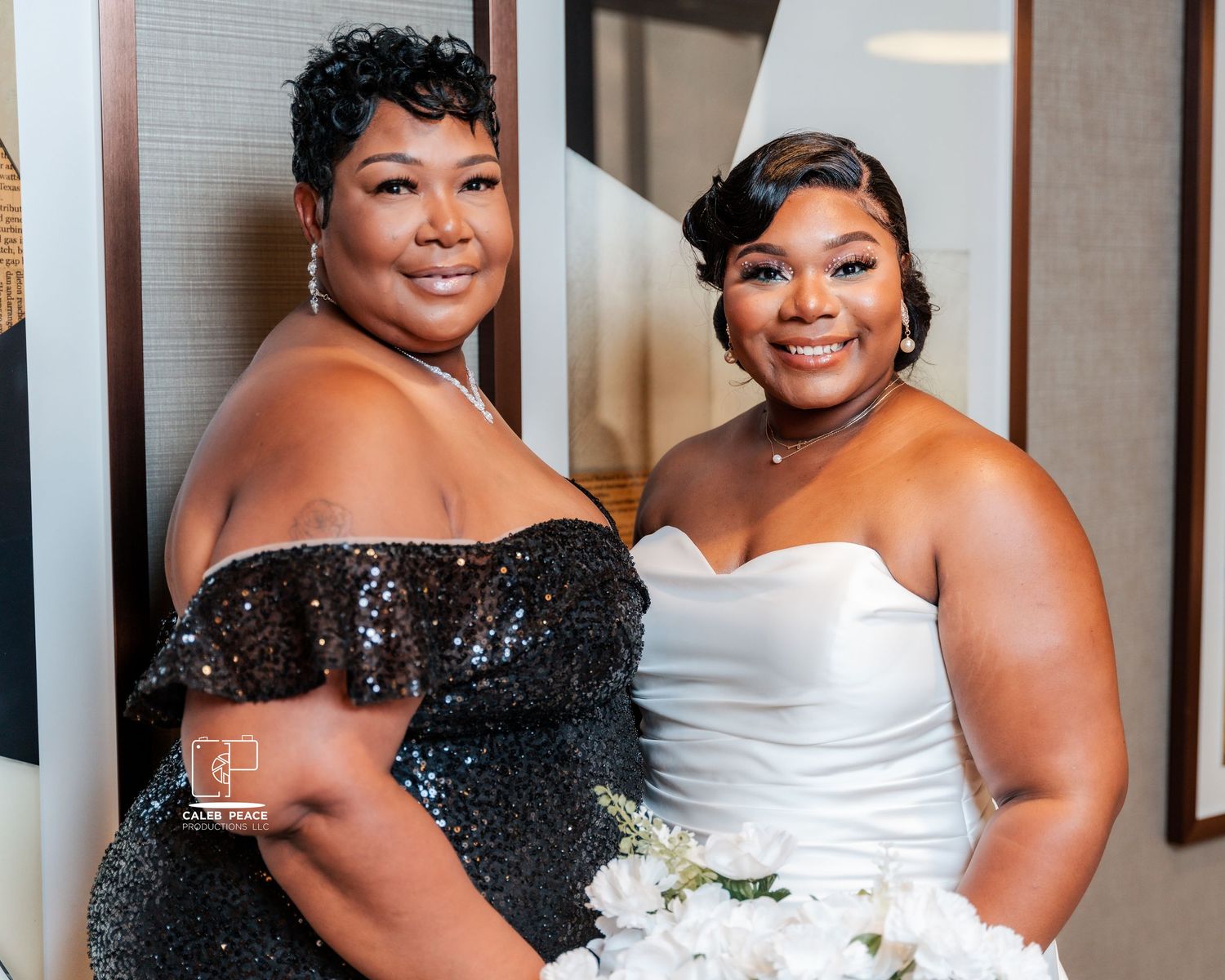 Wedding party members in black and white formal attire posing together.