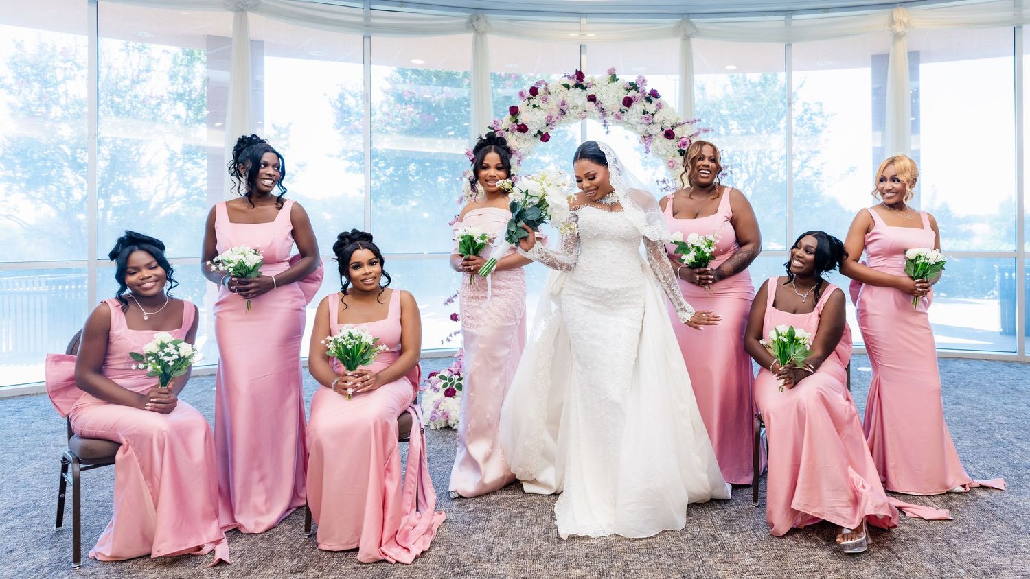 Wedding party in coral pink dresses poses together in a panoramic series of candid celebration shots.
