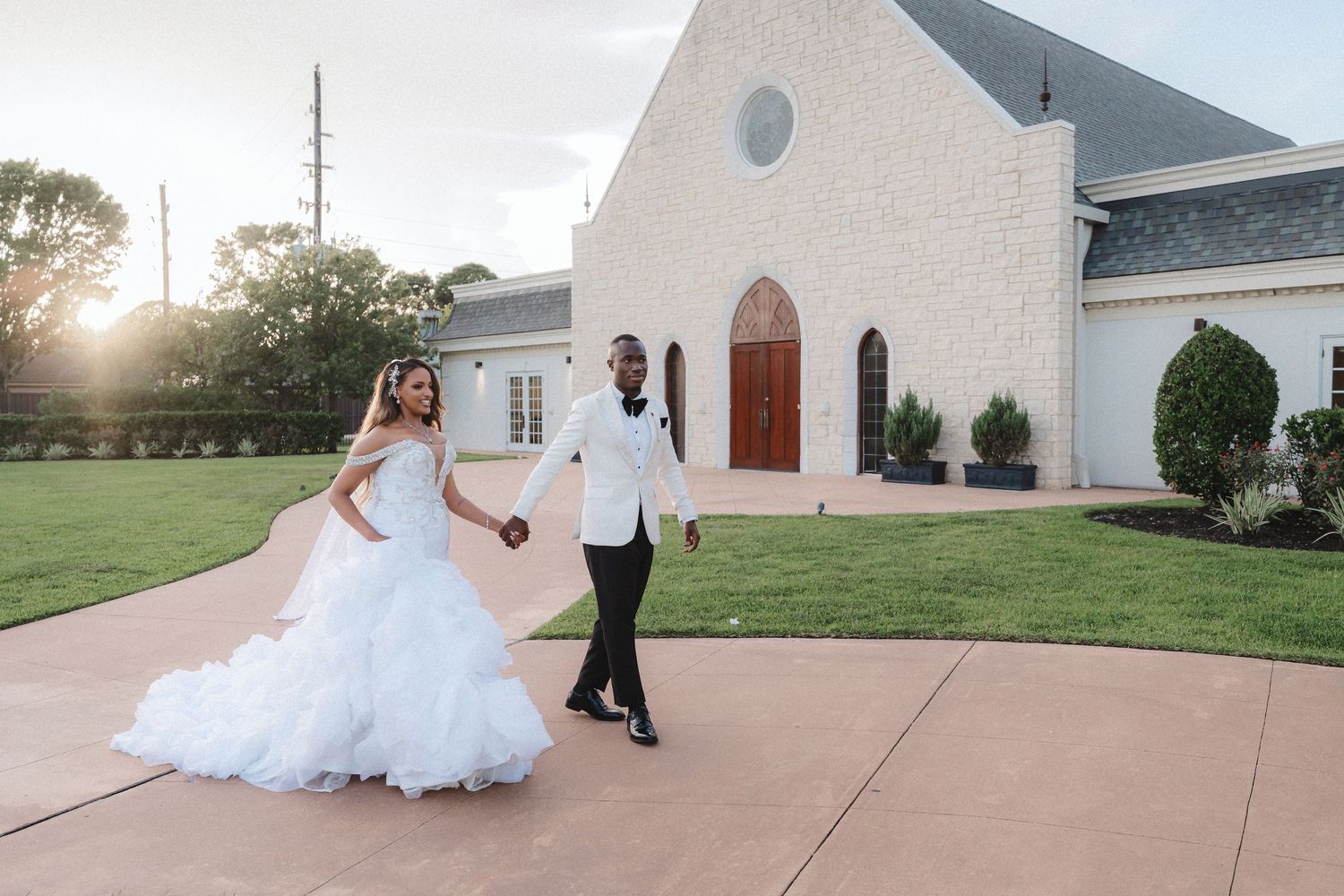 Panoramic wedding photo sequence showing a couple walking along a church pathway.