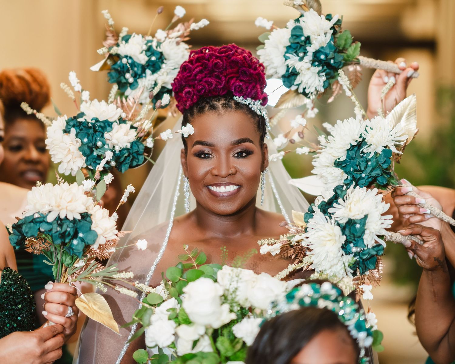Wedding party holds white floral bouquets against an elegant indoor venue backdrop.
