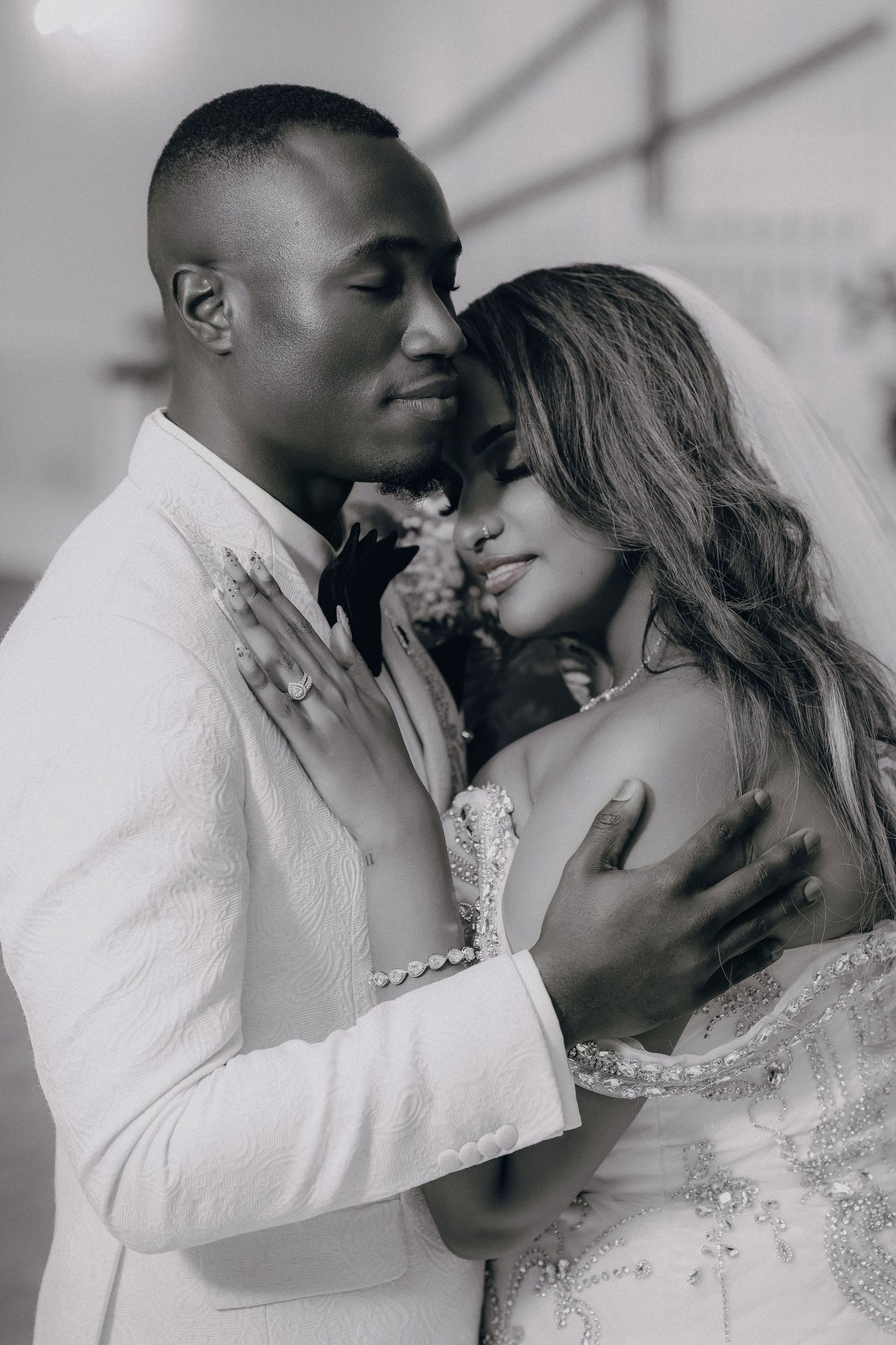 Intimate black and white wedding portraits showing tender romantic moments between newlyweds.