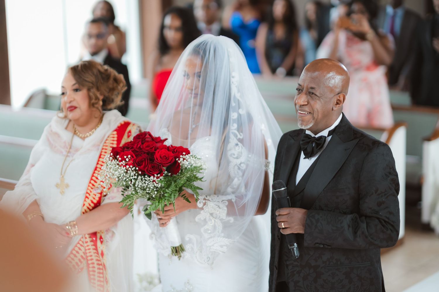 Wedding ceremony attendees share emotional embraces during a touching moment.
