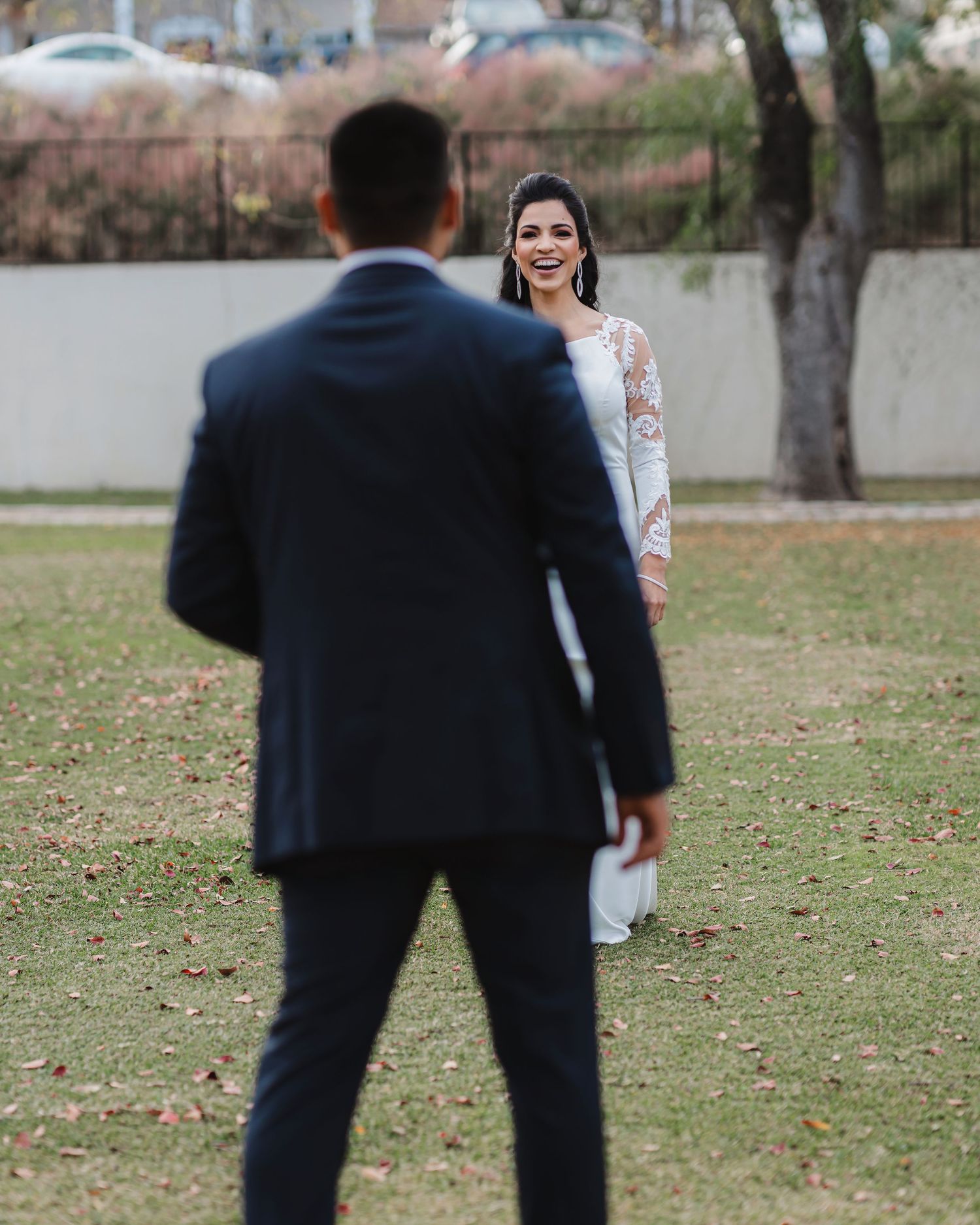 Wedding photo showing a couple having their first look moment in an outdoor garden setting.