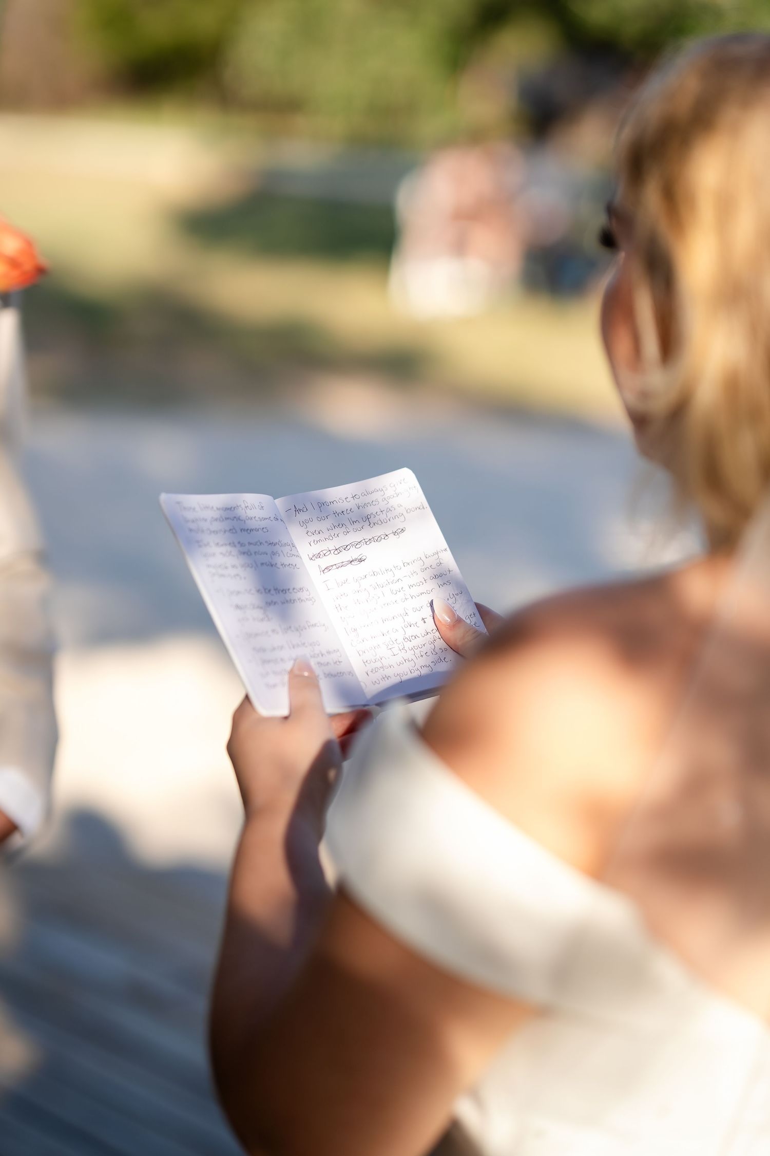 People reading handwritten notes outdoors on a sunny day.