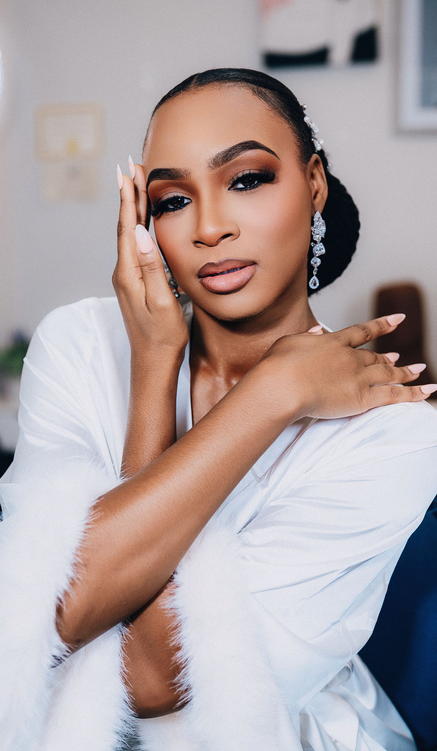 A series of glamour portraits showing elegant makeup and a white top against a light background.