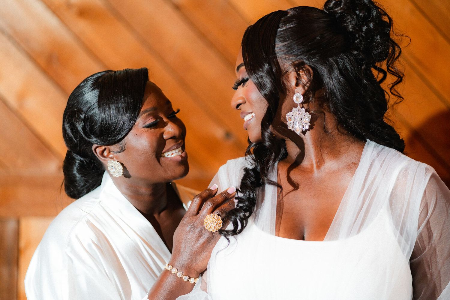 Joyful wedding couple sharing tender moments during their portrait session in warm lighting.