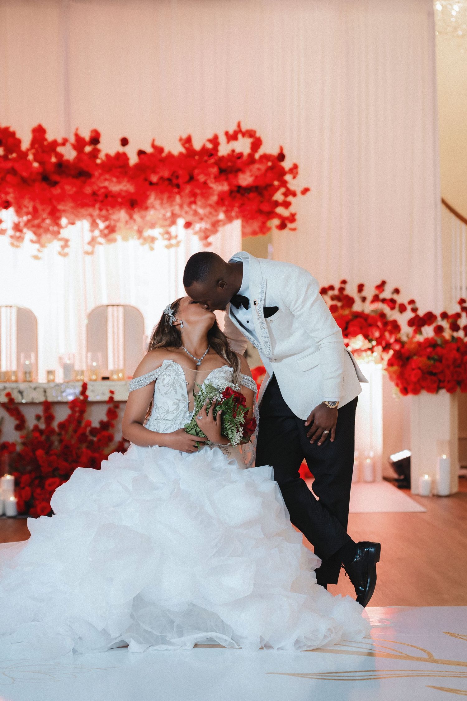 A sequence of wedding photos showing the couple in intimate poses with red floral arrangements.