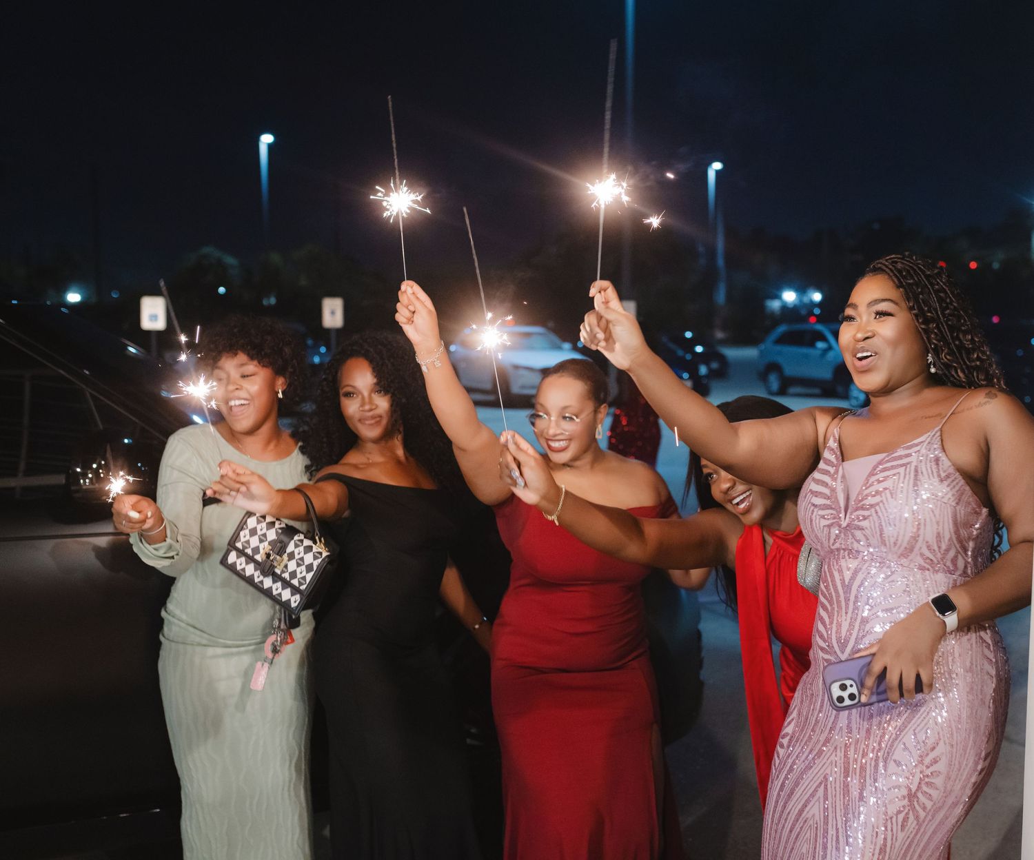 Wedding guests dancing and celebrating at outdoor nighttime reception.