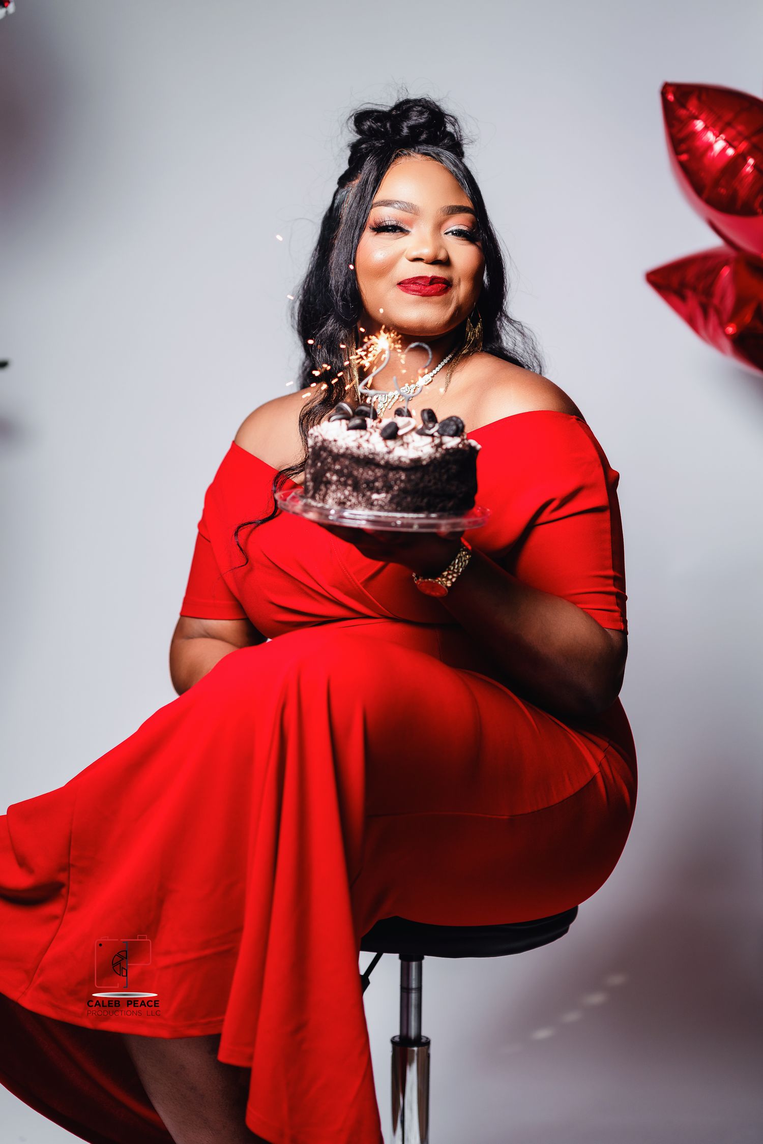 A figure in a flowing red dress poses elegantly against a light background in a fashion photoshoot series.