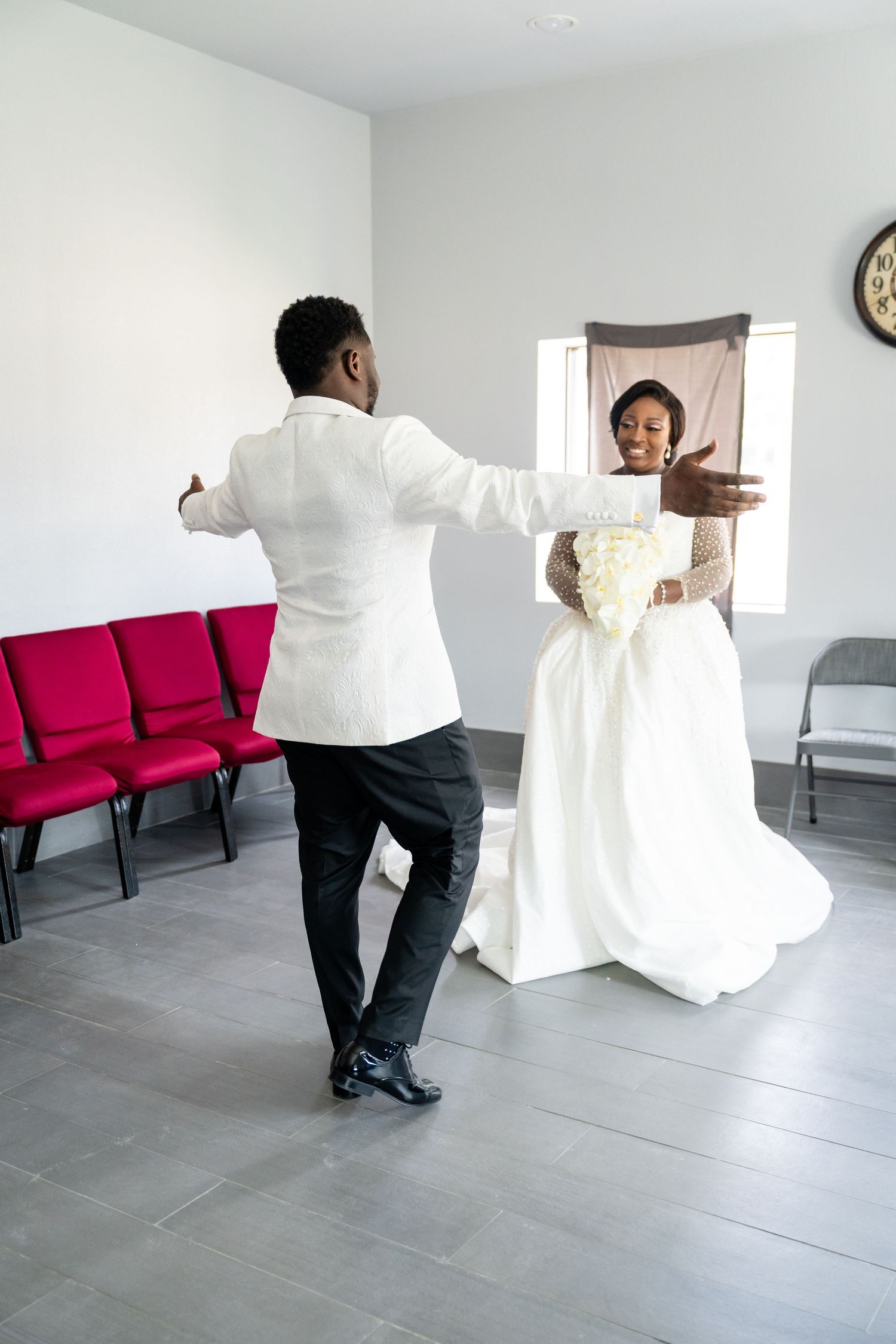 Wedding dress preparation sequence showing movement and flow of white gown against grey floor.
