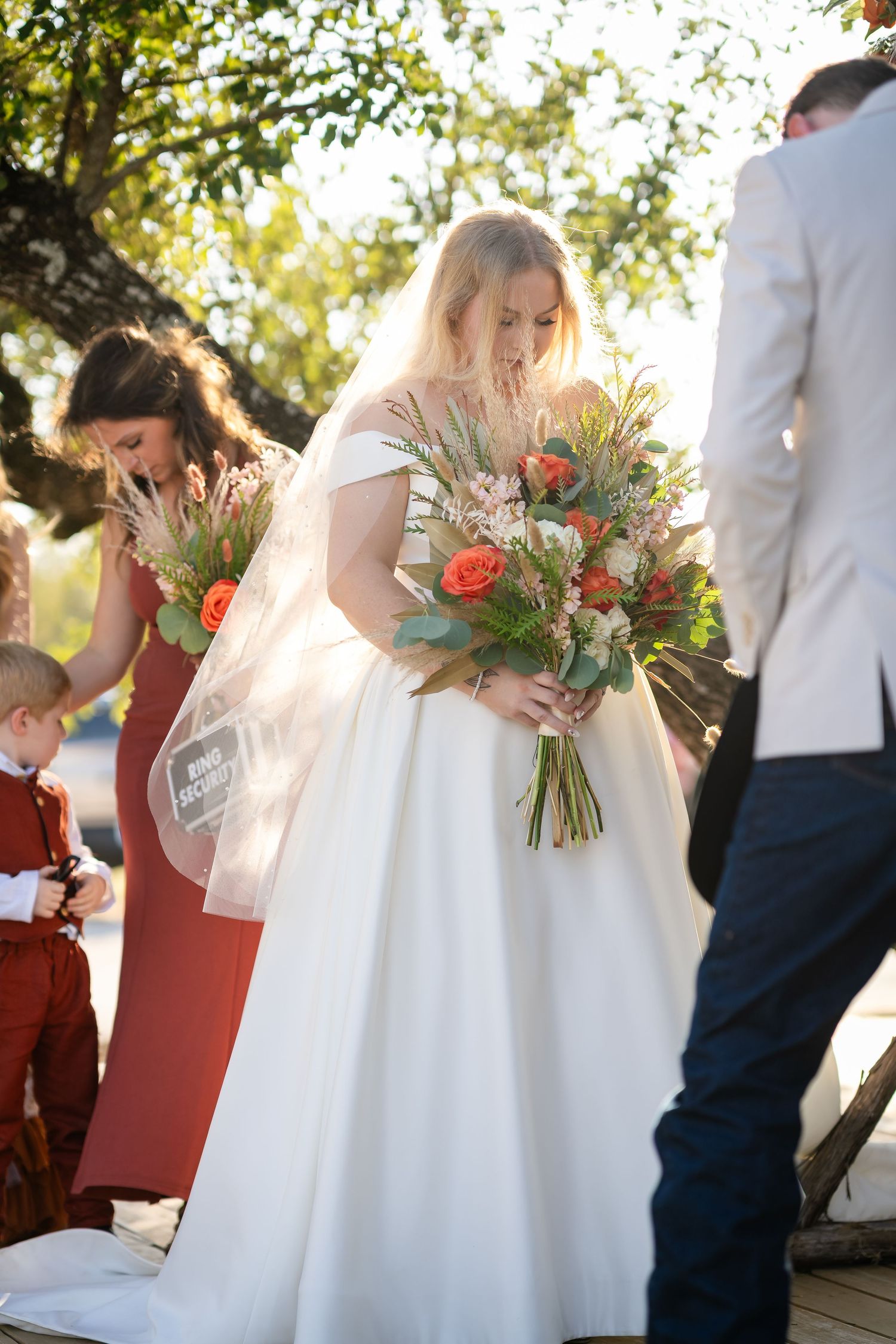 Wedding couple sharing candid moments outdoors with vibrant floral arrangements.