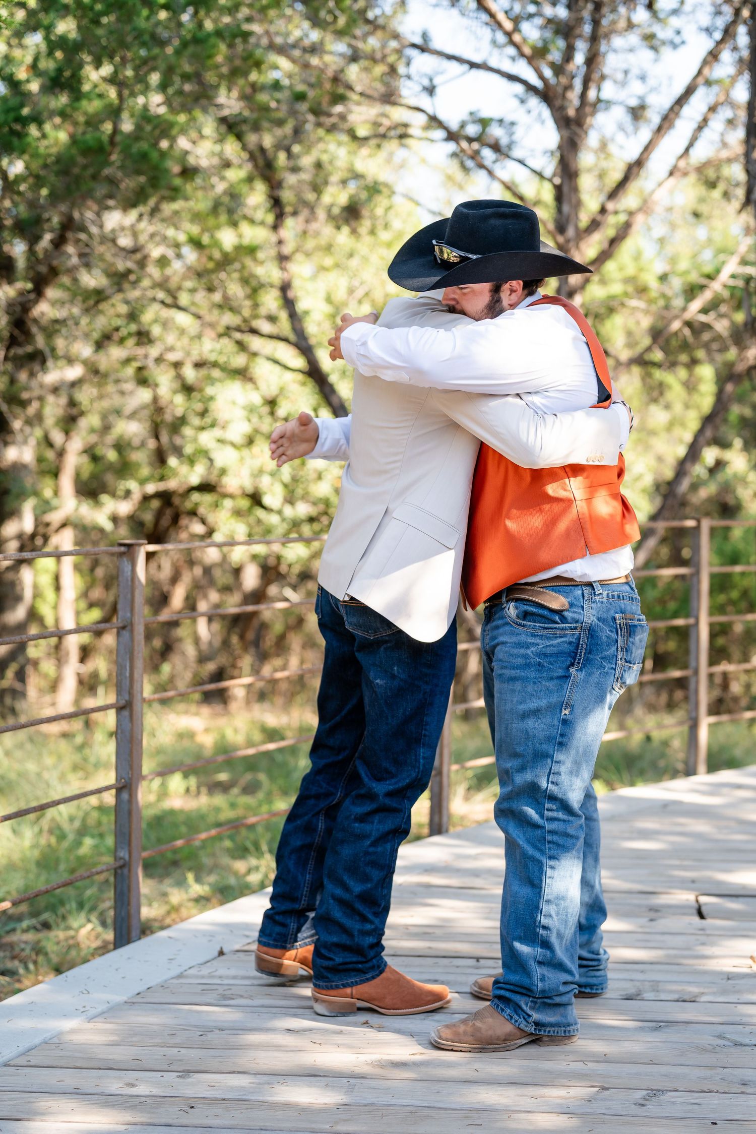 Playful sequence of two people dancing on a wooden deck with trees in the background.