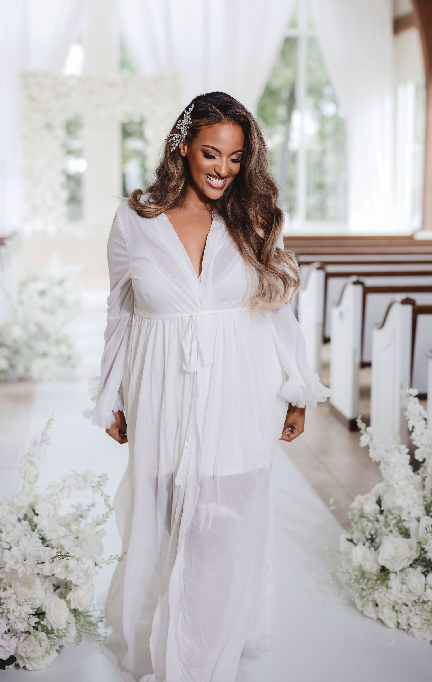 Bridal portrait session in an elegant white chapel setting with delicate floral decorations.