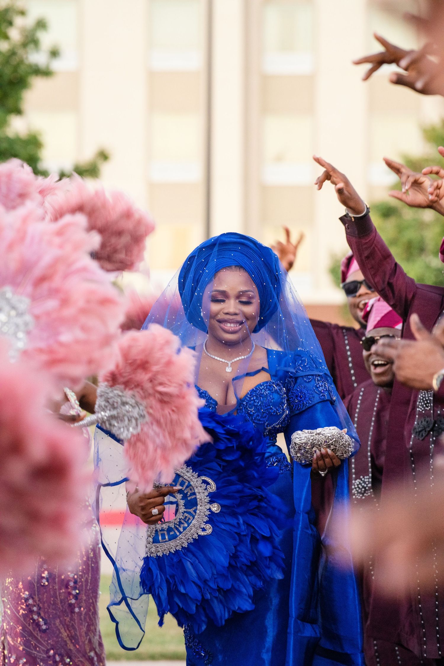 Celebratory scene with vibrant blue traditional dress and pink decorative elements.
