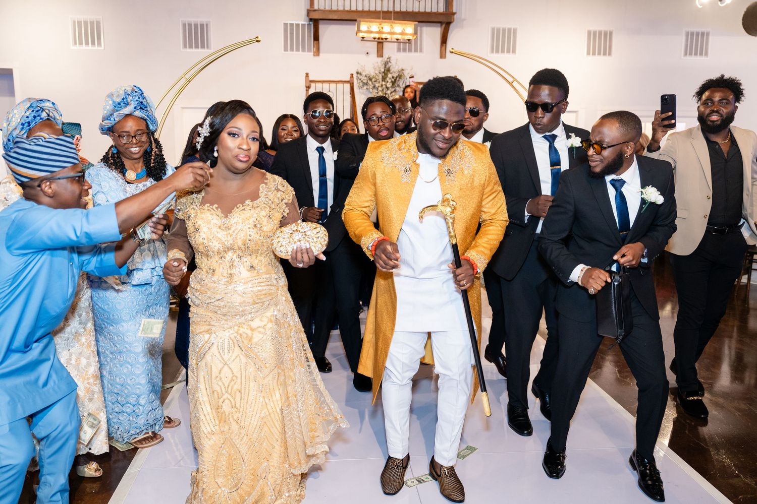 Wedding reception celebration with guests in formal attire dancing.