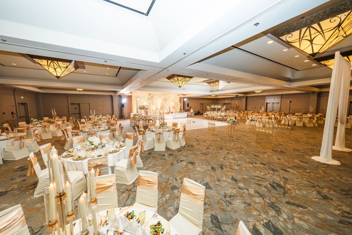 A luxurious wedding reception venue with elegant table settings, white linens, and warm lighting across multiple views.