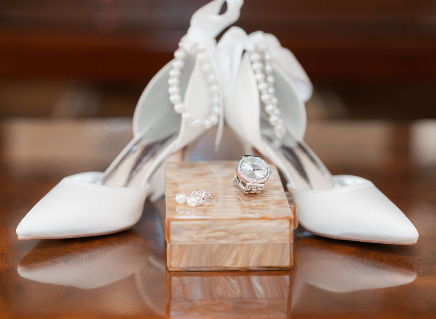 A series of wedding detail photos showing white bridal shoes and engagement ring on a wooden surface.