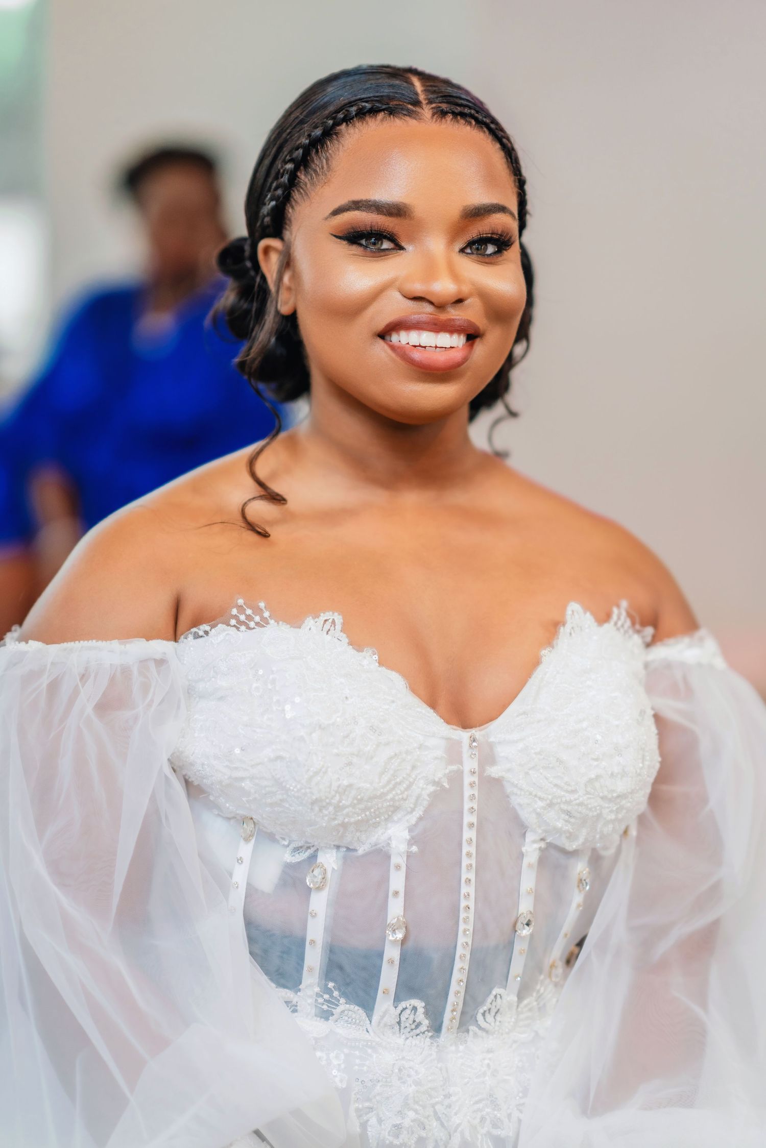 Close-up details of an elegant white wedding dress with delicate lace and sheer fabric.