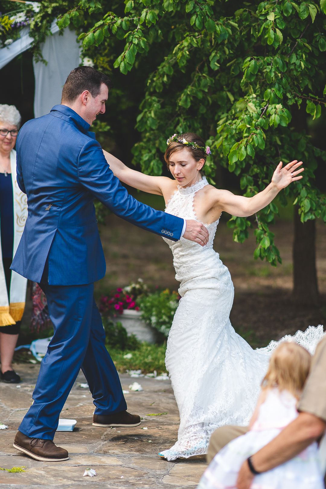 Couple dancing together at an outdoor wedding celebration.