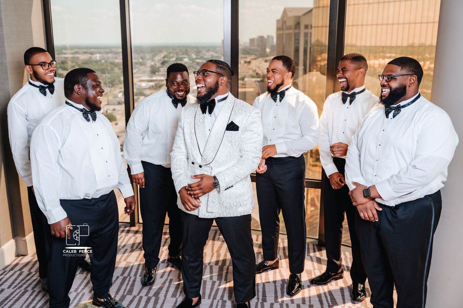 Groomsmen in white shirts and black ties gather for candid group photos at a wedding.